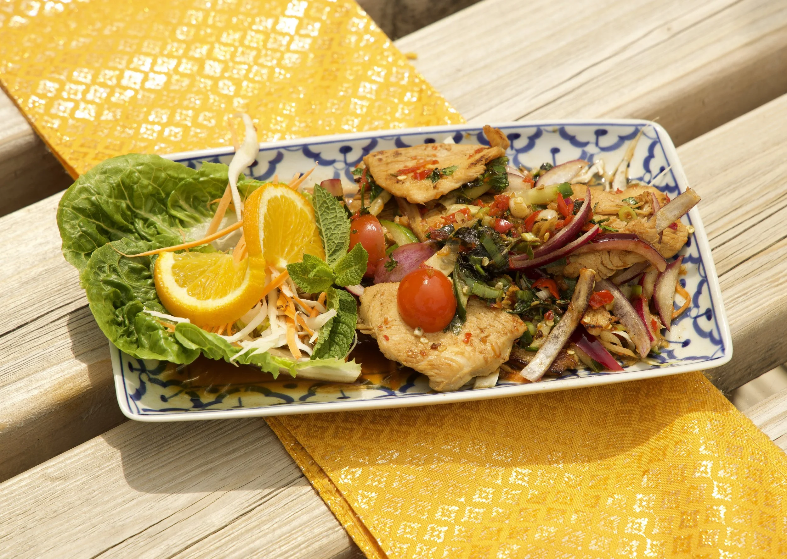 Close-up of Thai chicken salad at Jup Jup Thai Restaurant in Ludlow, made with fresh herbs and bold, authentic Thai flavours.