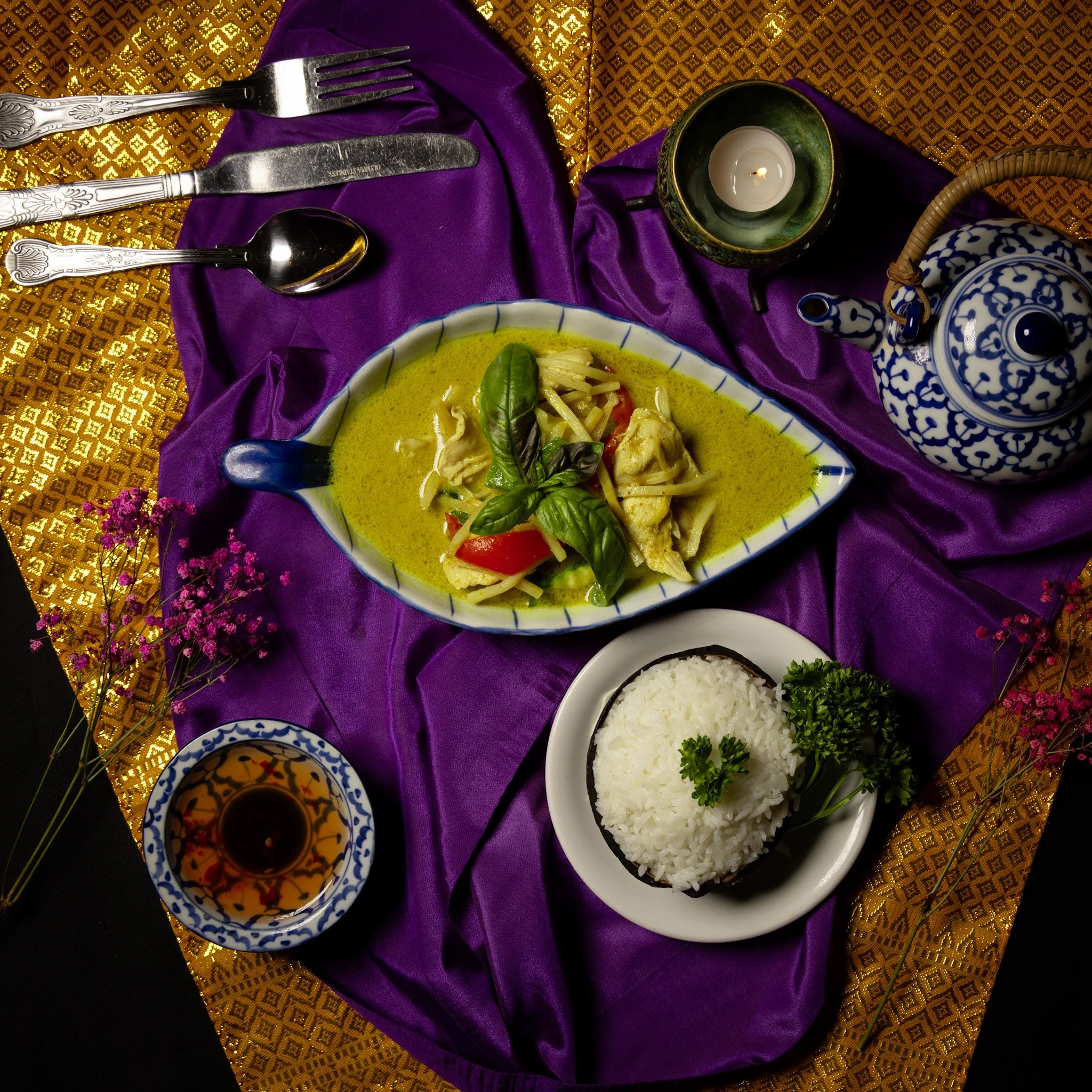 Traditional Thai green chicken curry with coconut rice and jasmine tea, served at Jup Jup Thai Restaurant and Bar in Ludlow, Shropshire.