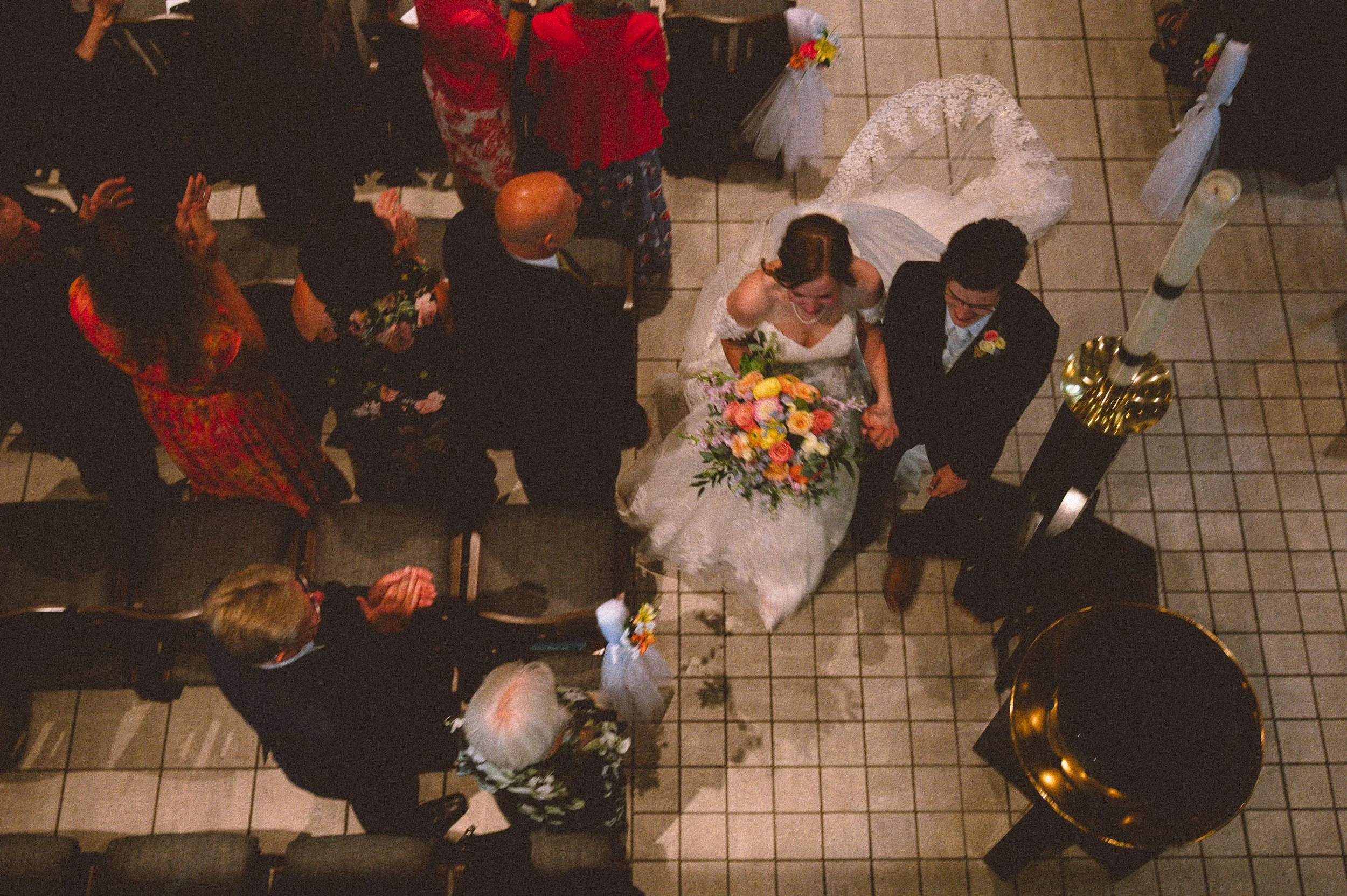 a bride and groom leaving their ceremony