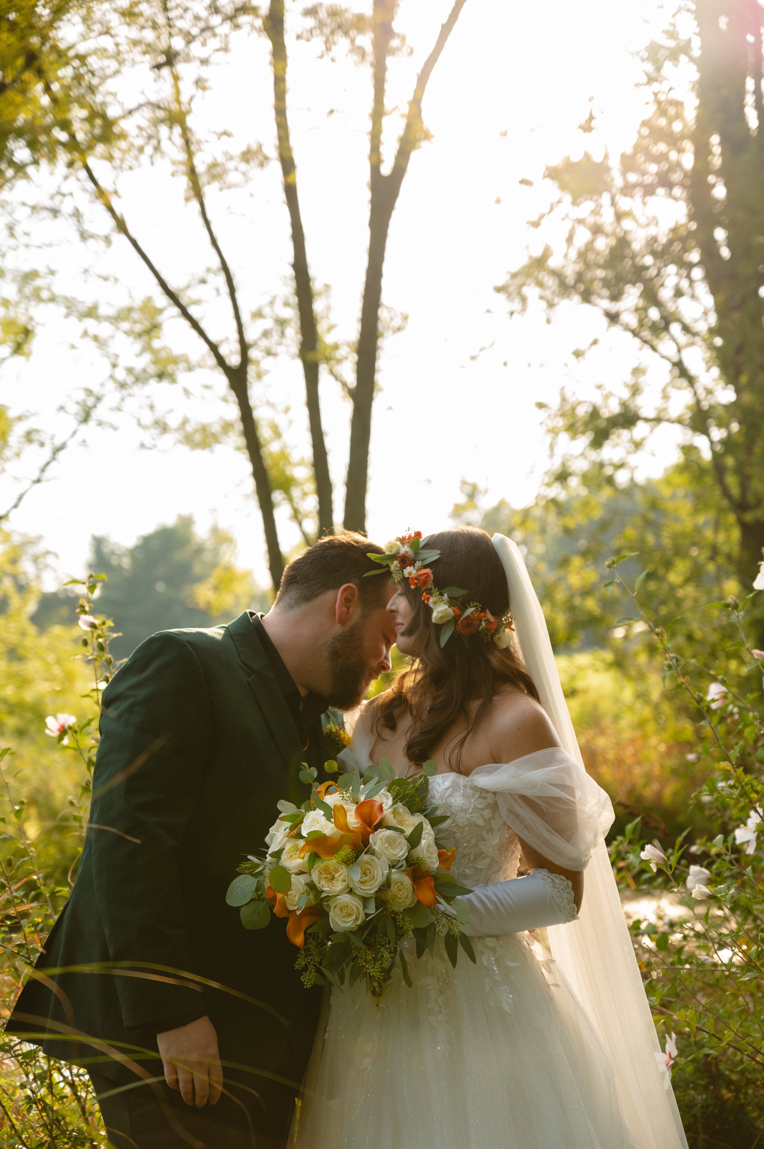 groom leaning in to give his bride a kiss on her clavicle