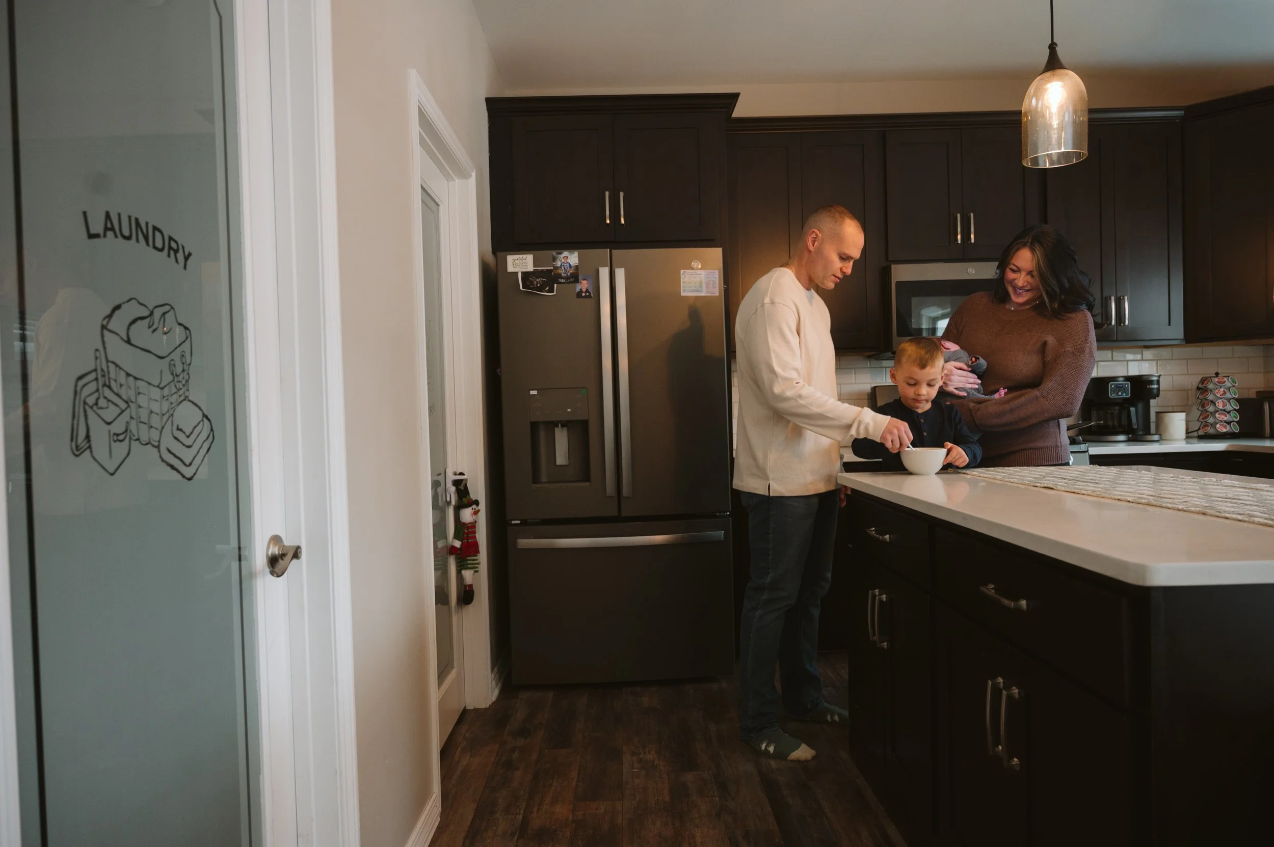 mom dad baby and little making breakfast in their kitchen