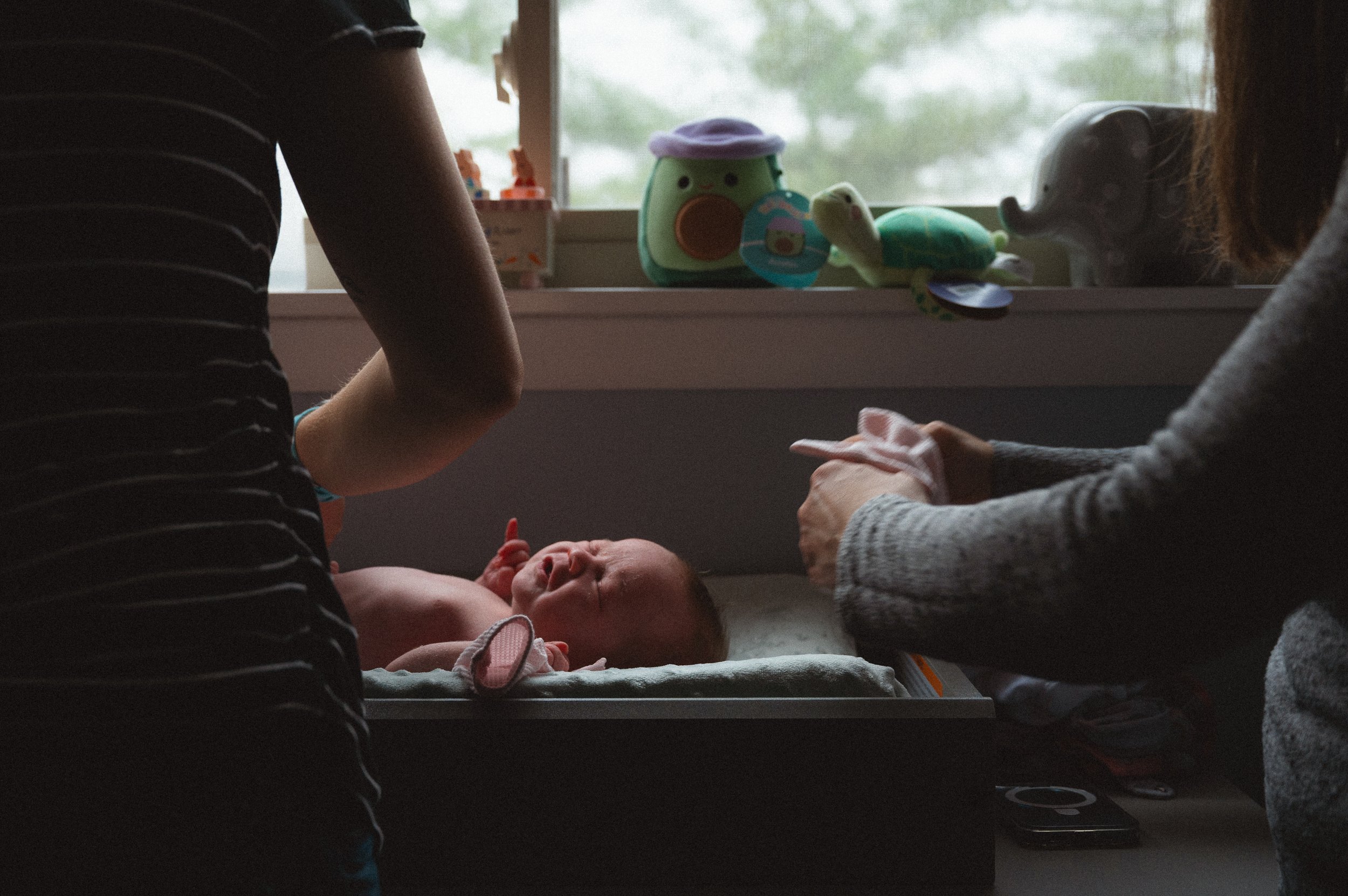 mom and mom getting their newborn ready for the day