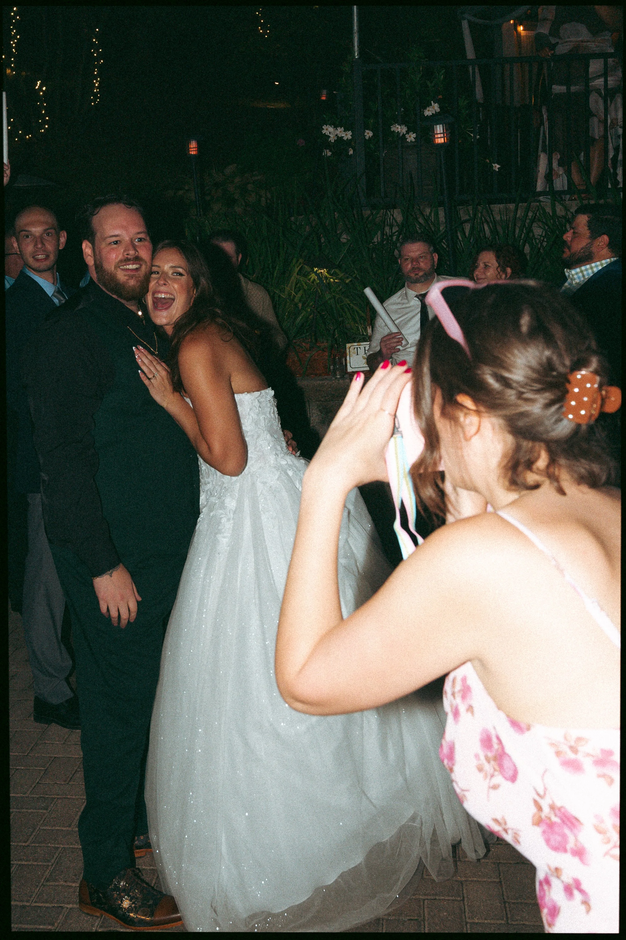 guys shoots candid photo of the bride and groom
