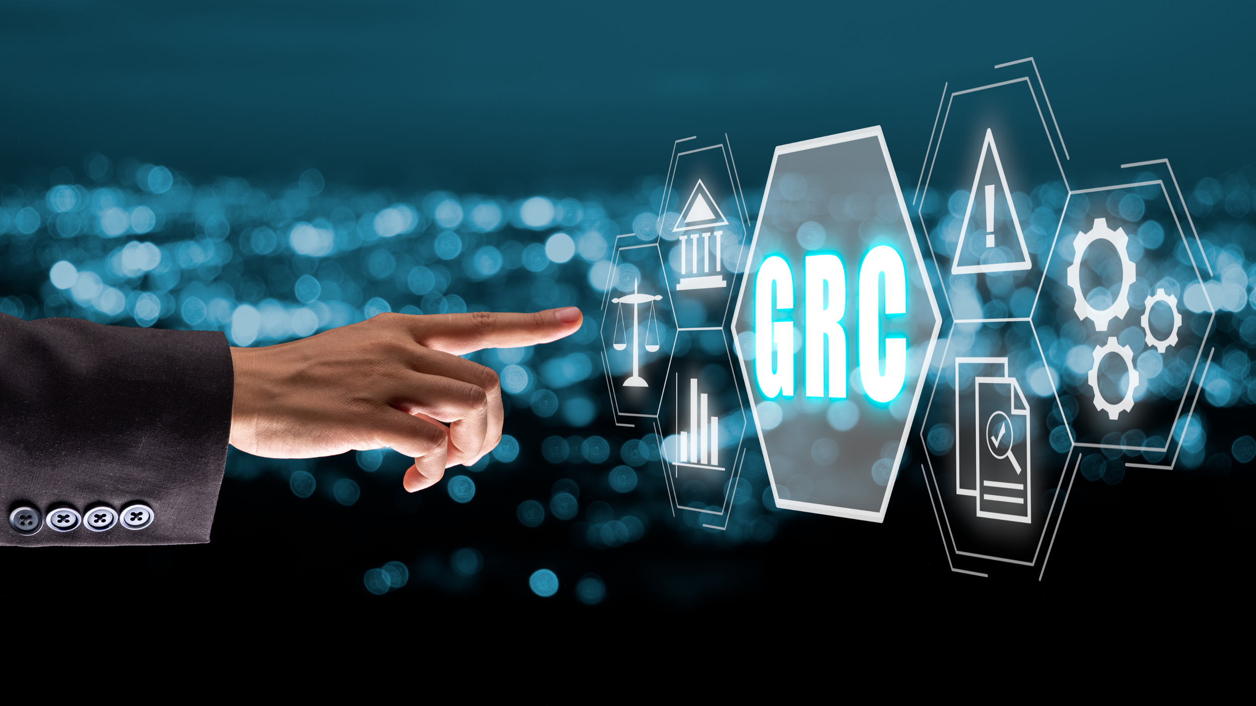 Businessperson in a suit pointing at a digital graphic with the text 'GRC' and icons related to legal, security, and data management.