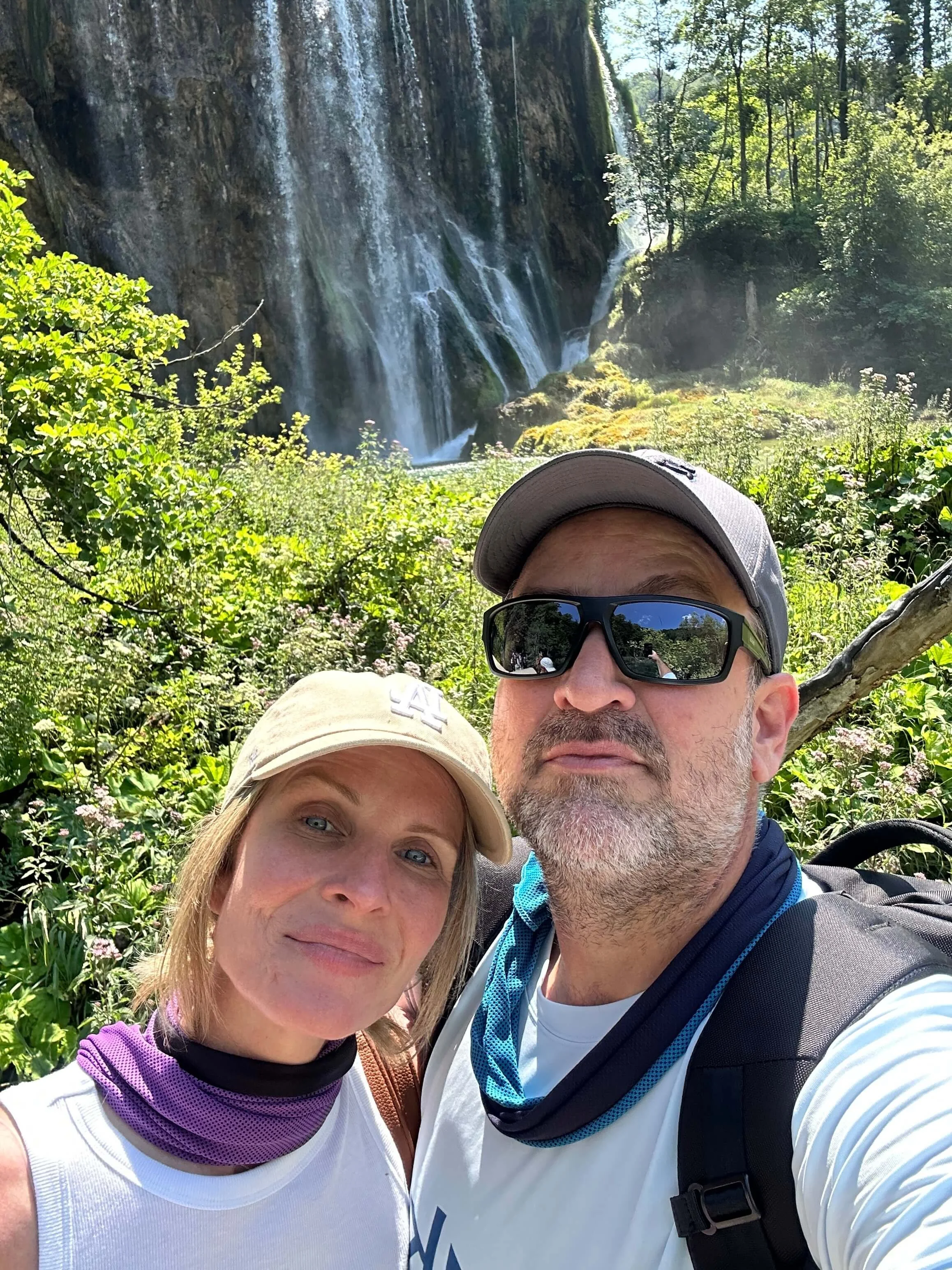 Melissa Greenwood CFP hiking with husband by waterfall