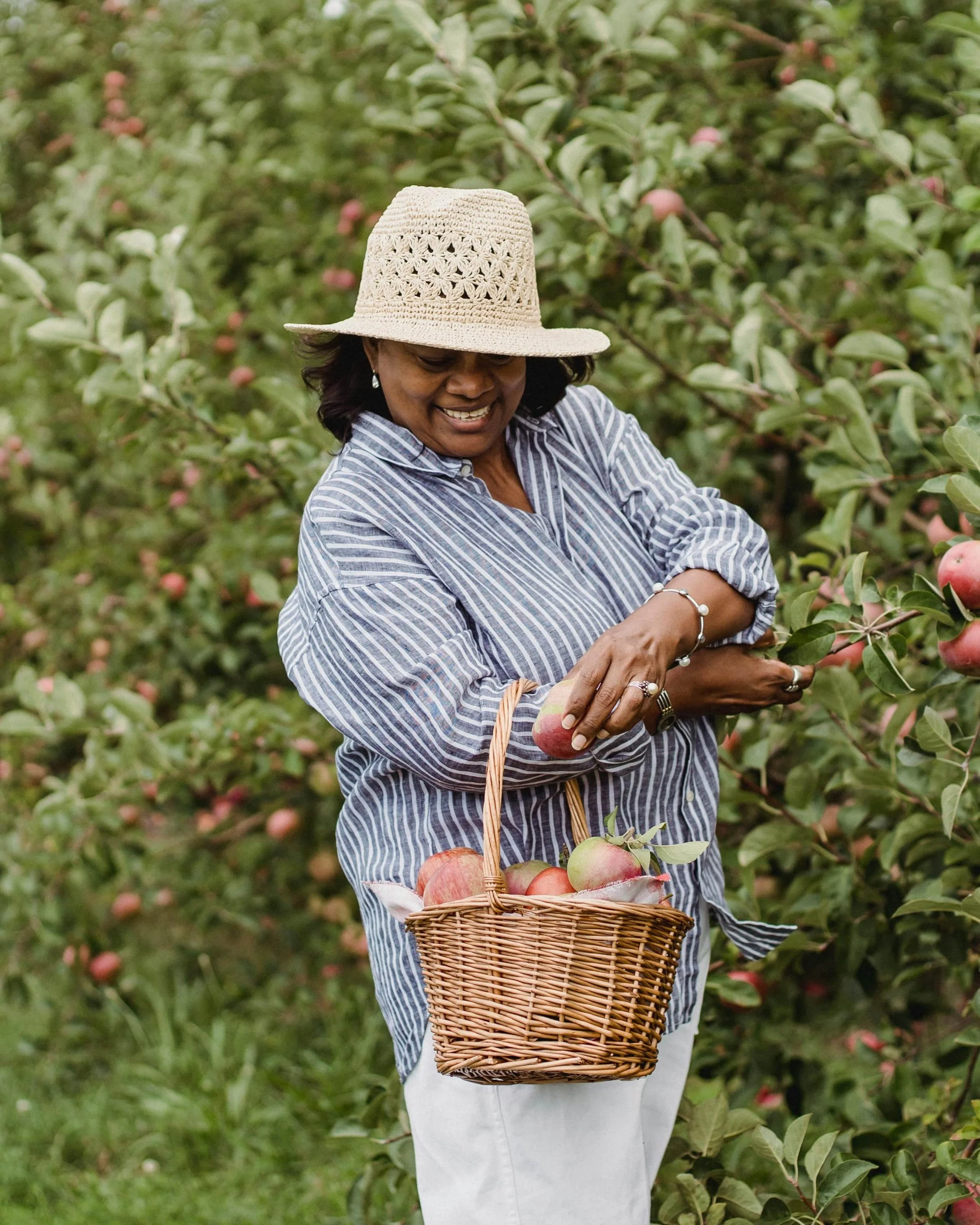 woman in apple orchard with basket
