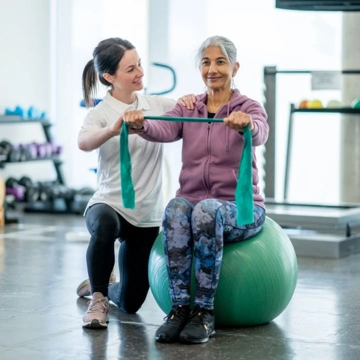 Physiotherapist supporting a patient during rehabilitation exercises, suitable for chronic muscular pain, fibromyalgia and neuropathic conditions at Kerala Ayurveda Clinic Leicester