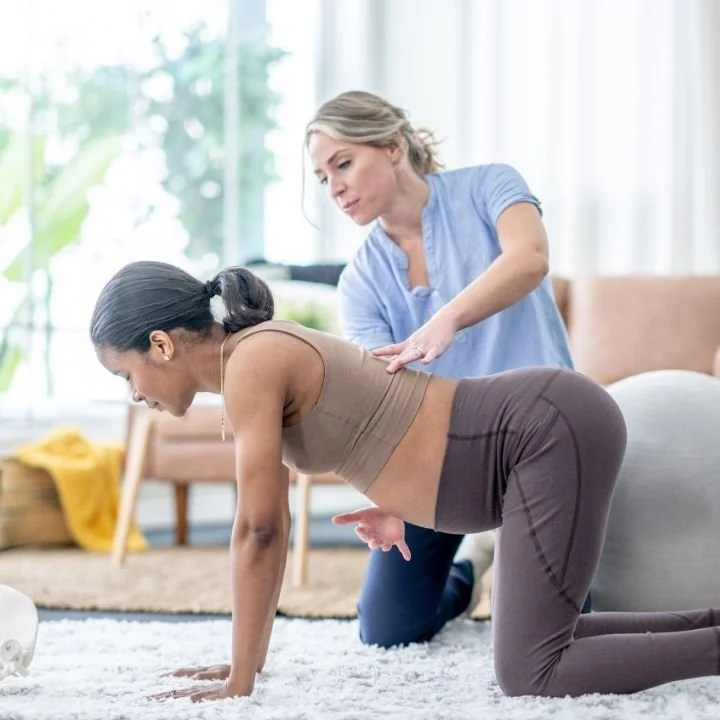 Physiotherapist guiding postnatal rehabilitation exercises to support core strength, posture and recovery after pregnancy at Kerala Ayurveda Clinic Leicester.
