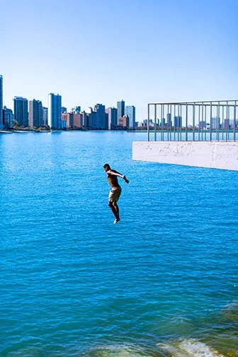 DIVE, ’24 
 
Limited Edition of 9 and 3AP 
Signed by the Artist 
17” x 22” | “30 x 40” 
 
Digital Photography | Handheld Color photograph of subject taking a plunge in Lake Michigan | Archival pigment print 
 
“An instinctual reaction with my camera 