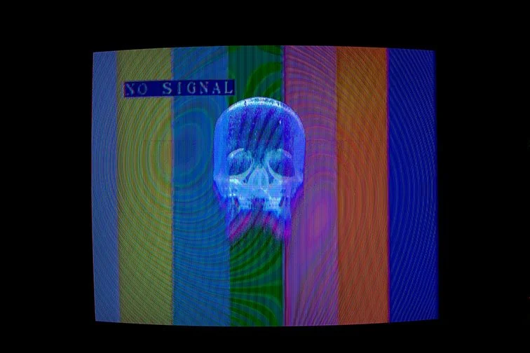 POLTERGEIST, ’25 
 
Limited Edition of 9 and 3AP 
Signed by the Artist 
17” x 22” | “30 x 40” 
 
Digital Photography | Long exposure photograph of a CRT television displaying my circuit-bent Photograph, “5g CELLULAR SERVICE” | Archival Pigment print