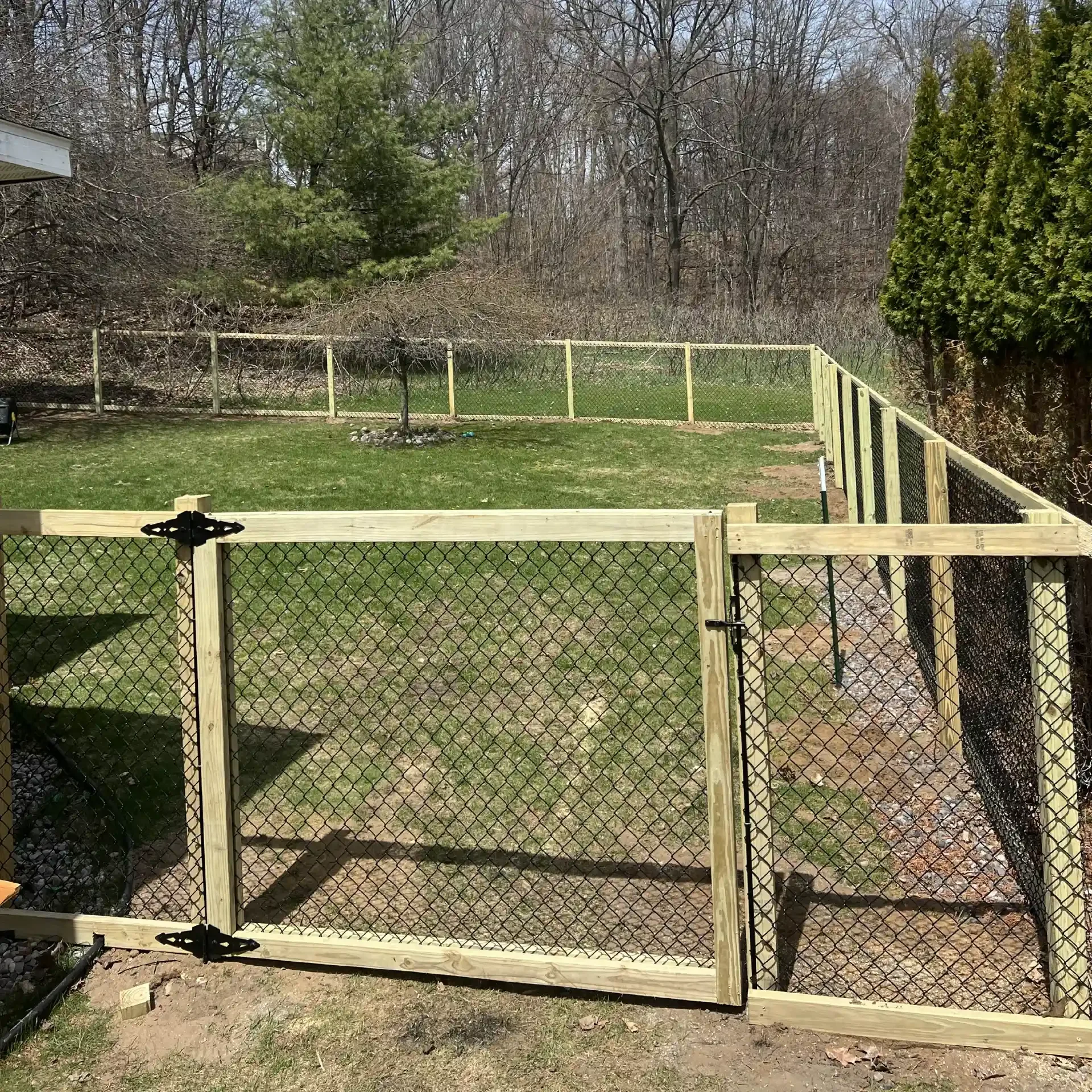 wood framed black chain link fence