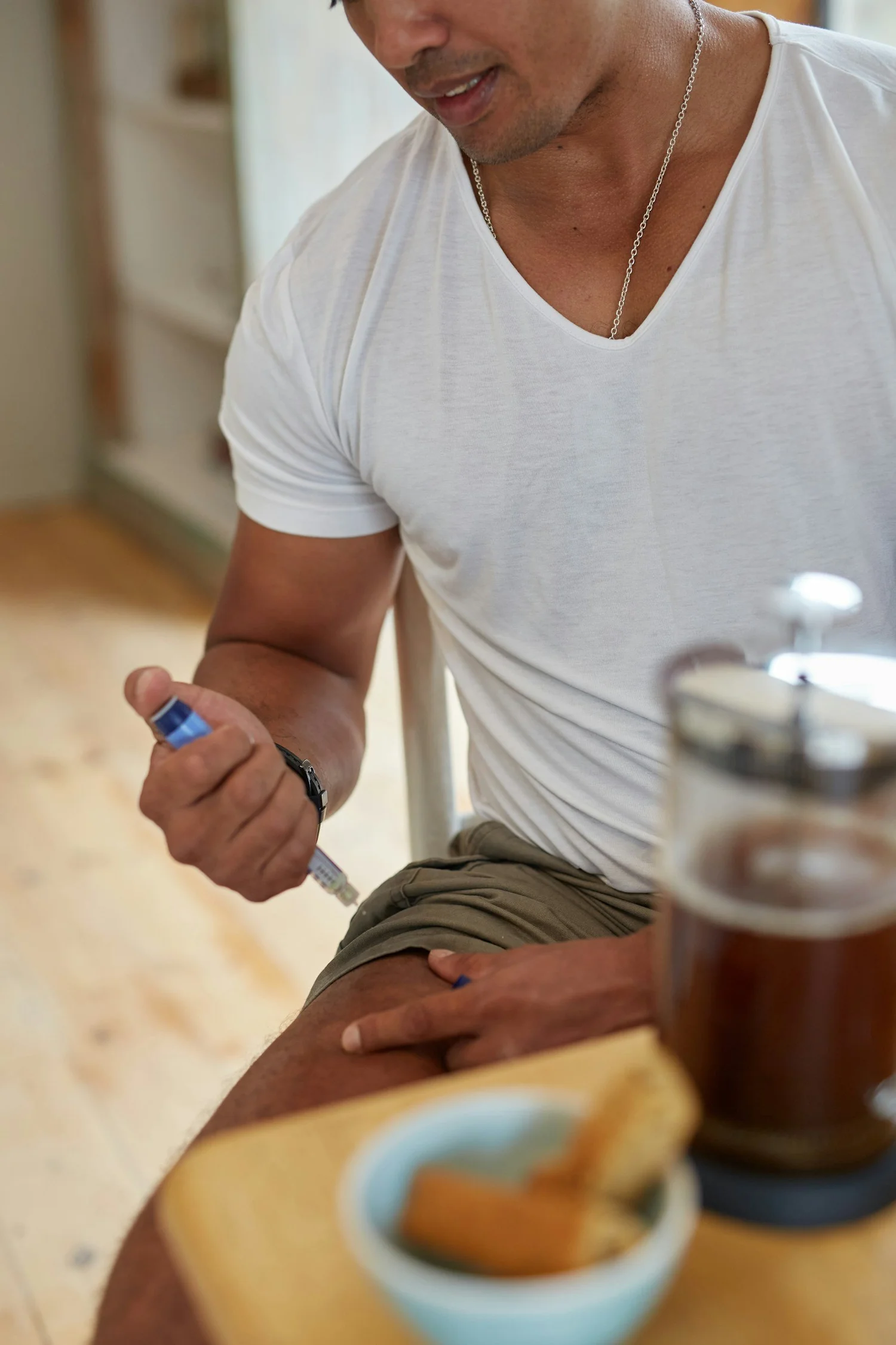 Patient using a weekly weight-loss injection pen