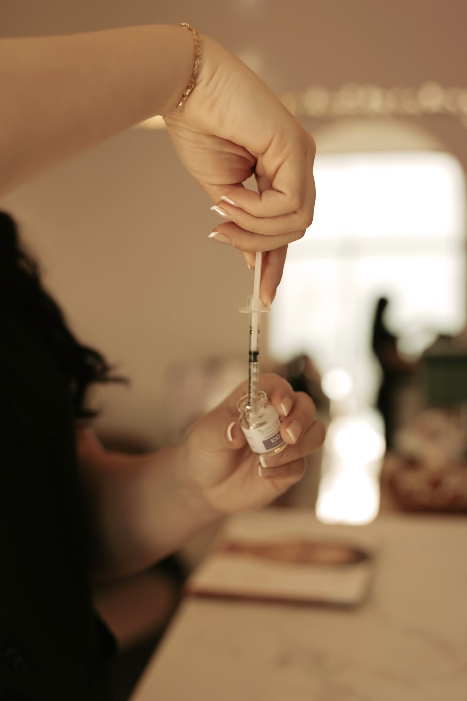 Injector drawing product into a syringe in soft window light