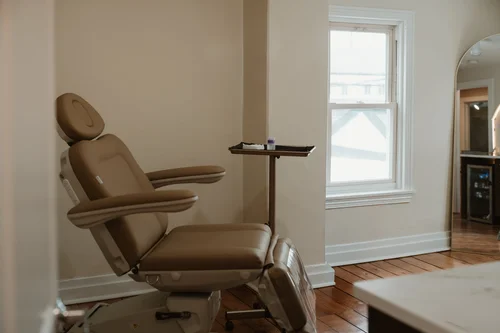 Bright treatment room with a cream treatment chair at CoCo Aesthetic — view more on Instagram