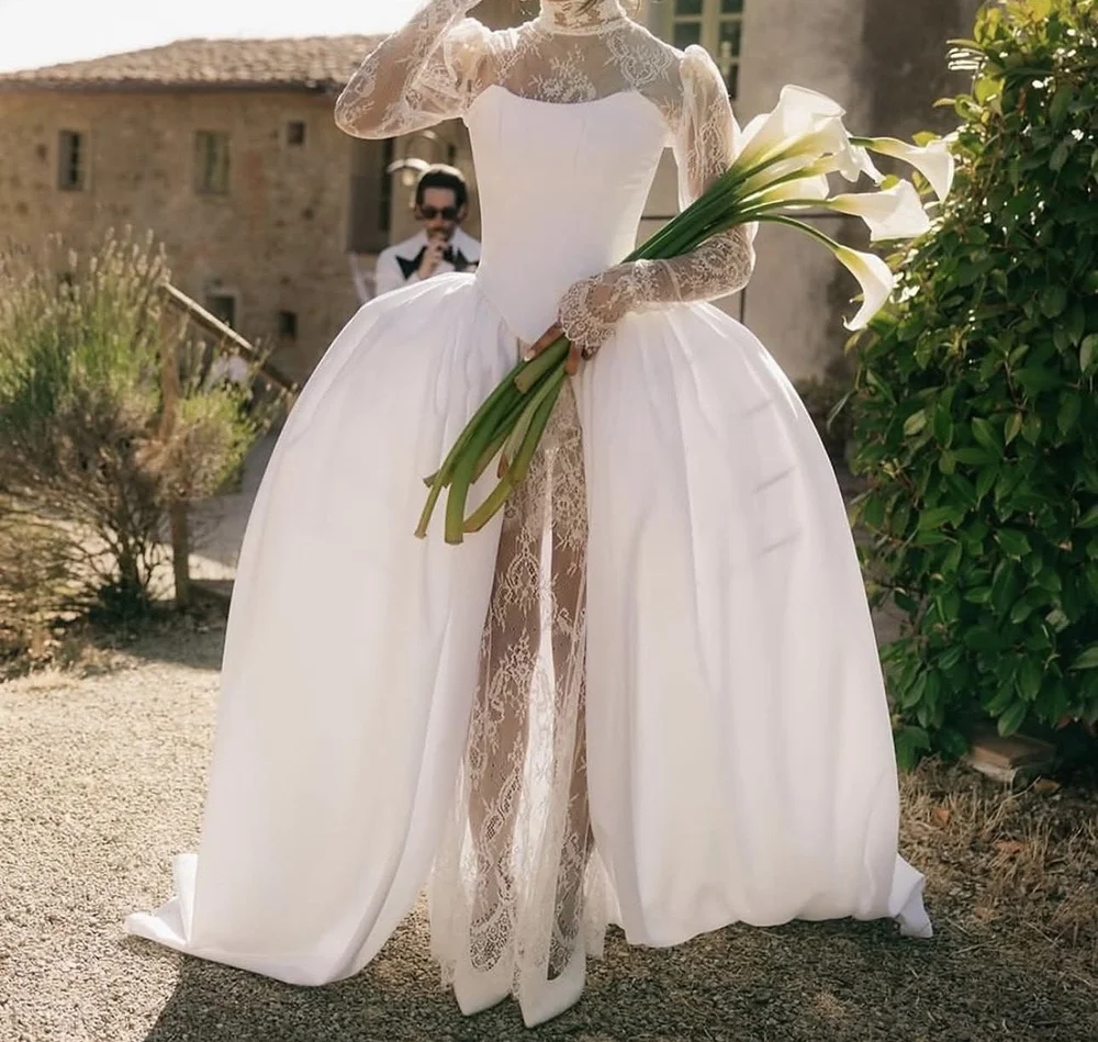 Bride in a flowing gown holding calla lilies