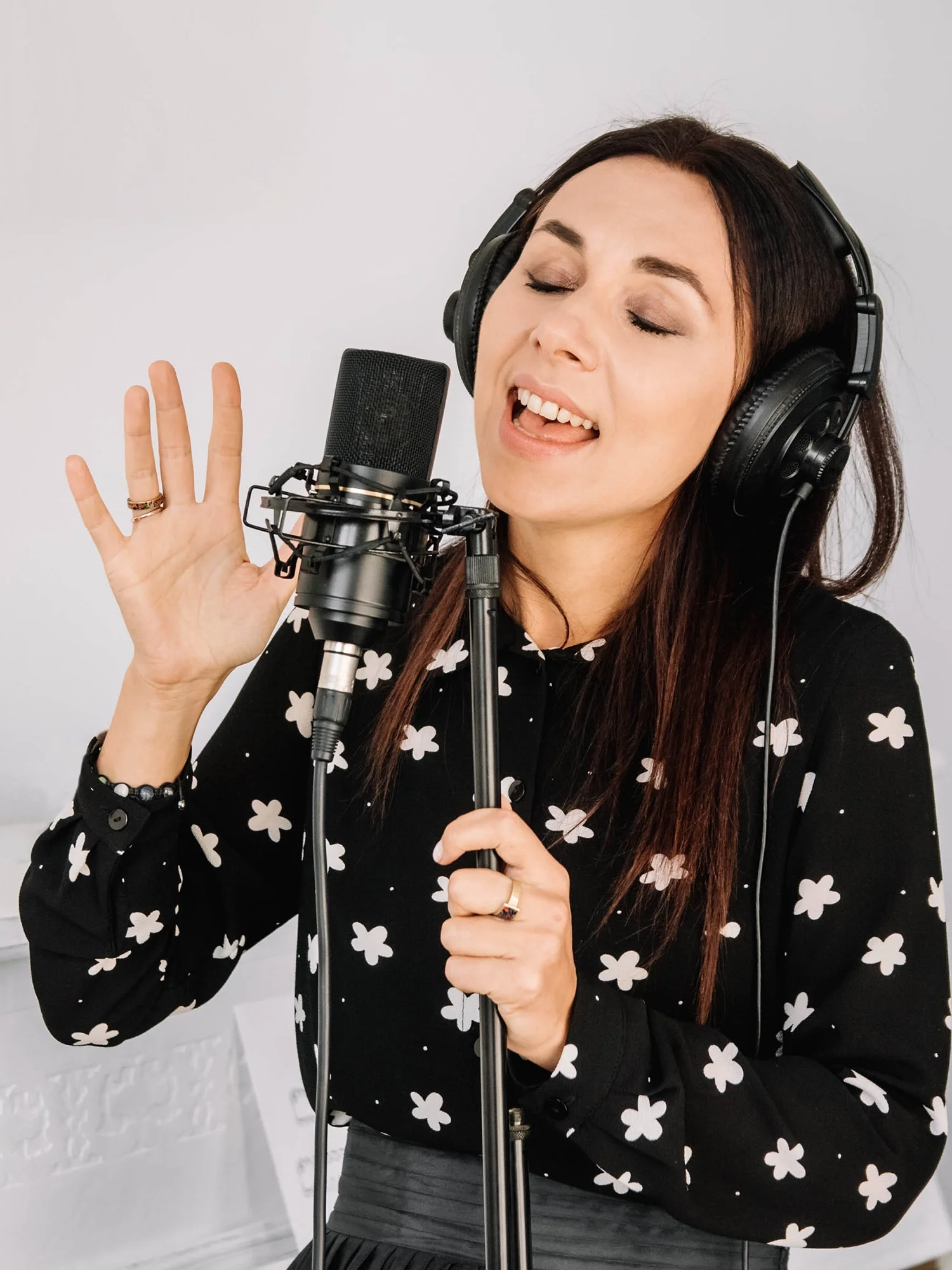 woman signing in front of microphone CST for singers