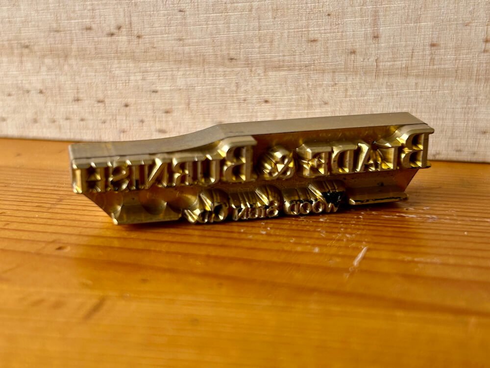 Close up of custom made branding iron tip of company logo