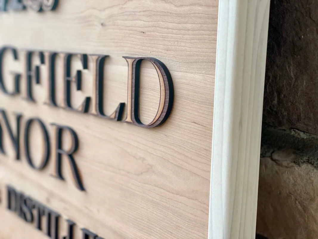 A close up shot of the framing of a custom wood sign. Winery business wood sign, cherry and poplar.