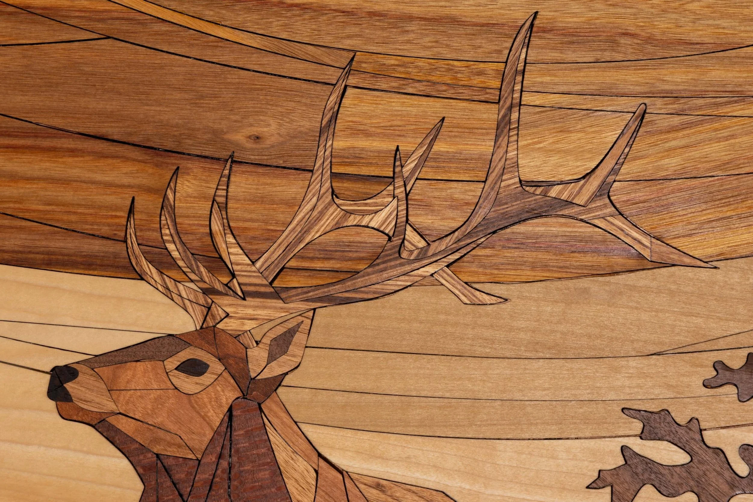 A wooden puzzle depicting a deer with antlers among leaves and branches.