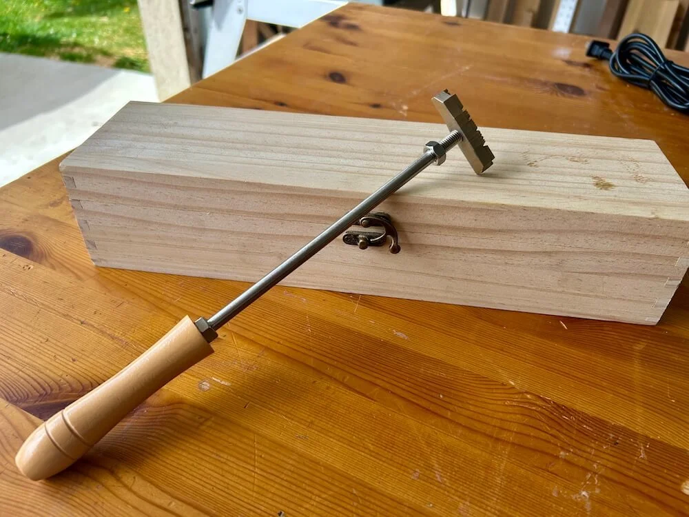 The full branding iron with the natural wooden handle