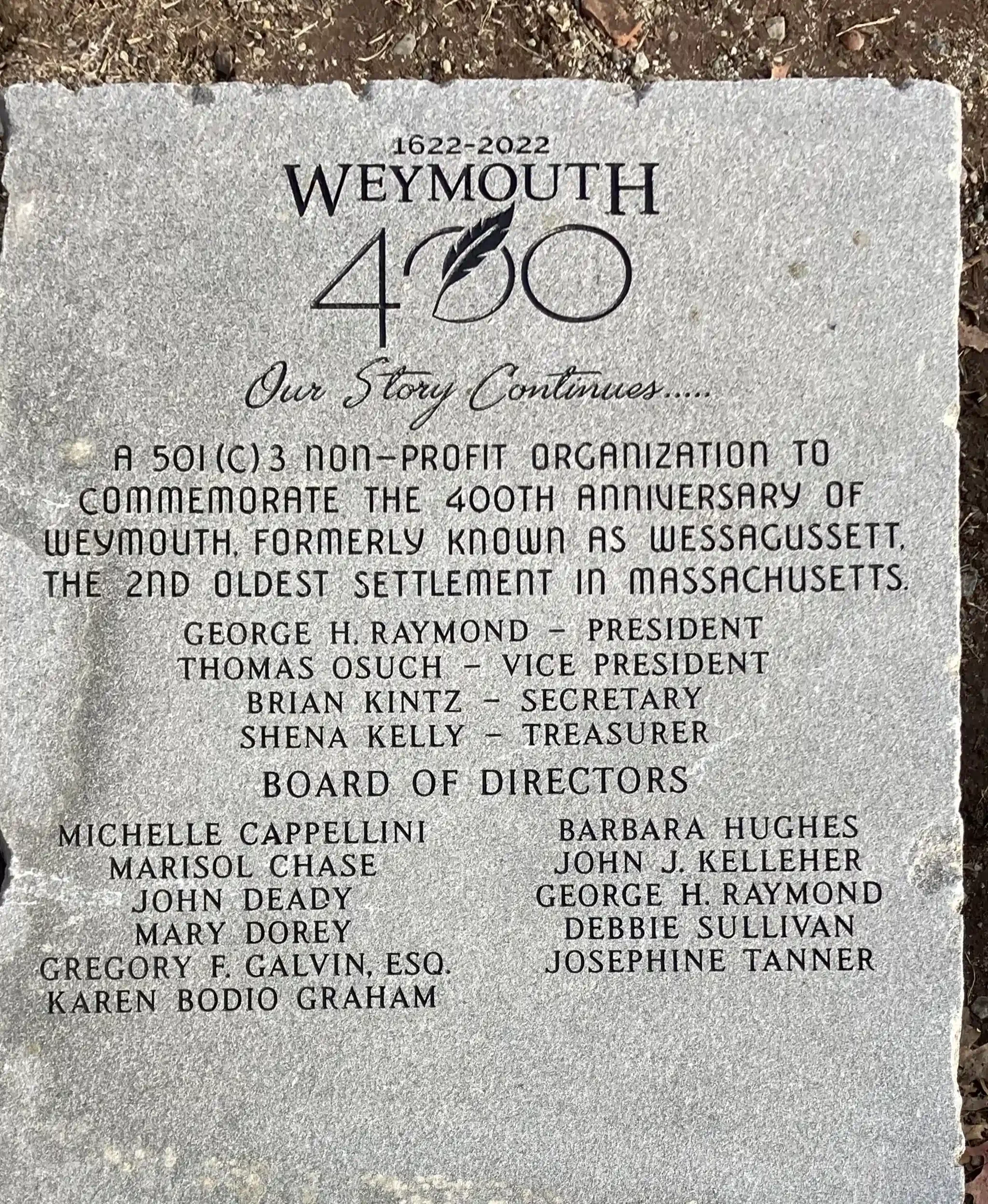 A commemorative plaque marking the 400th anniversary of Weymouth, Massachusetts, with the text '1622-2022 Weymouth 400 Our Story Continues...' and a list of former and current officials.