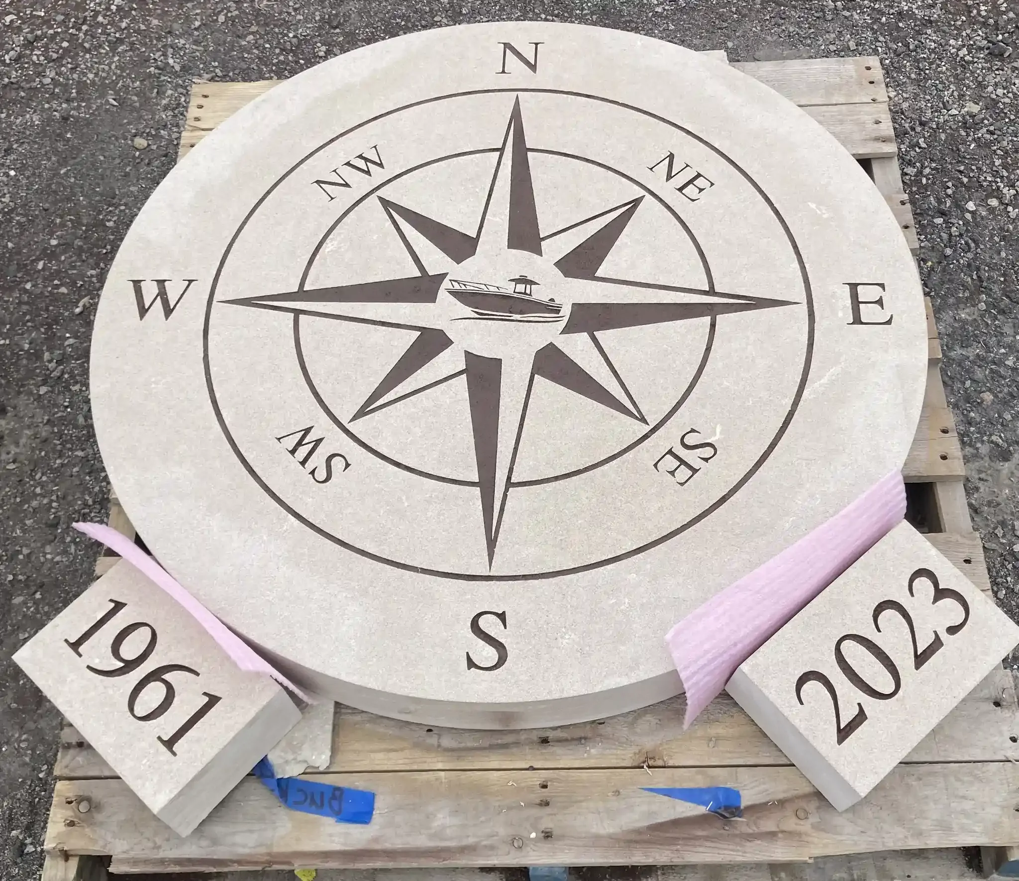 A round stone with a compass rose.