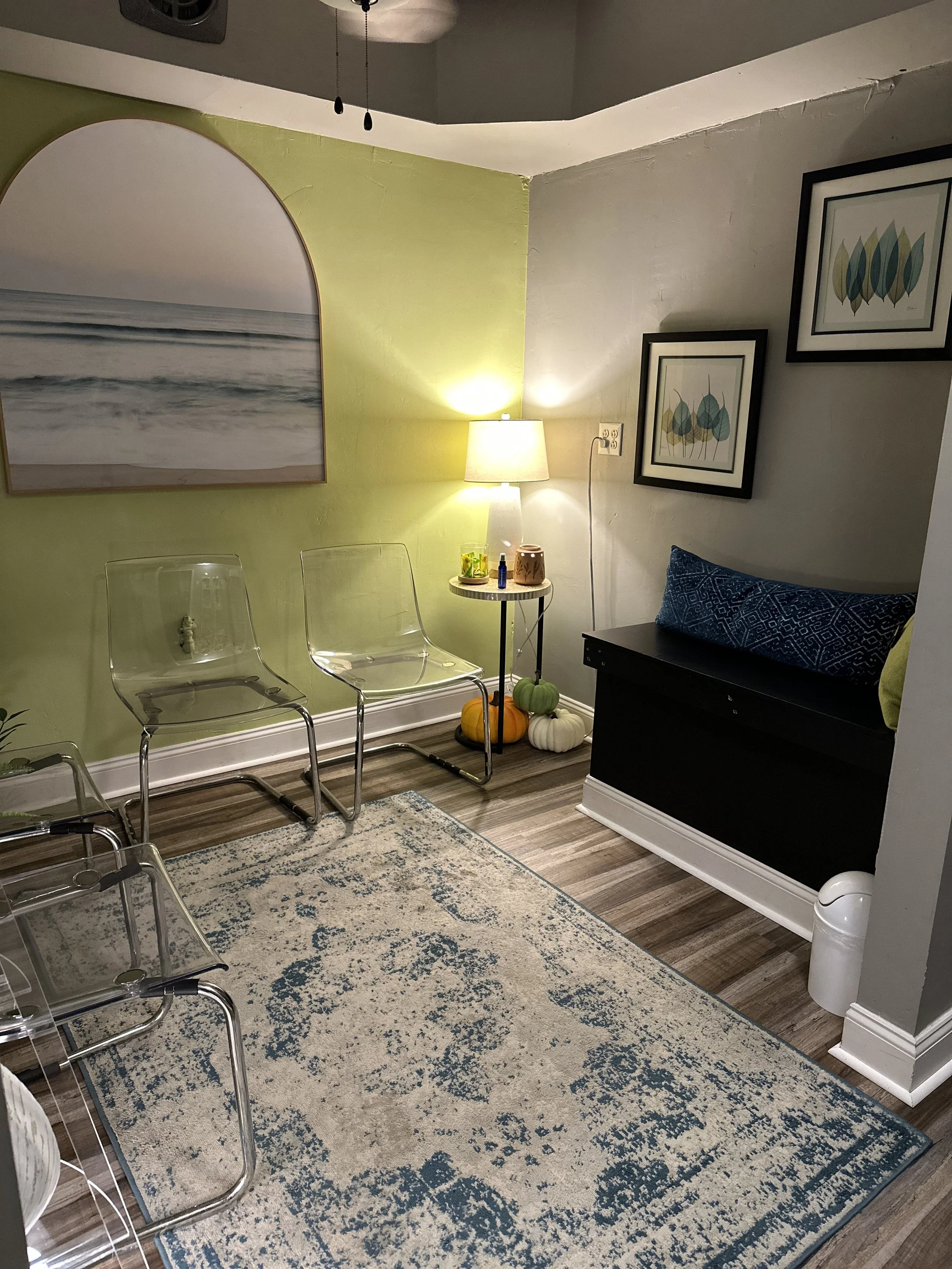 waiting room with four chairs and a bench, calm lighting and decor