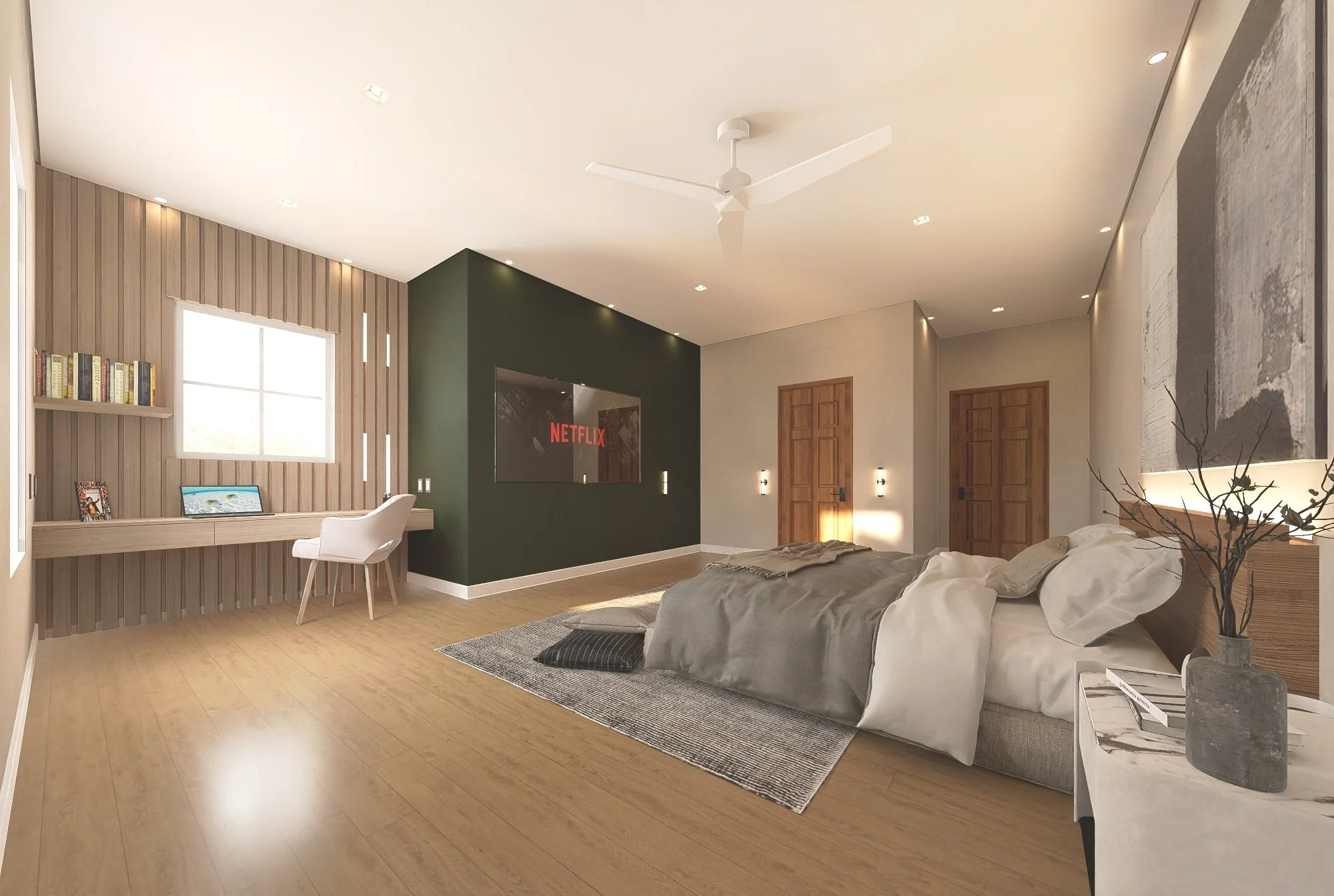 Modern bedroom with a large bed, wooden flooring, and a green accent wall with a built-in television displaying Netflix. There is a window with natural light, a desk with books and a laptop, and a ceiling fan. The room has a minimalist decor with neu