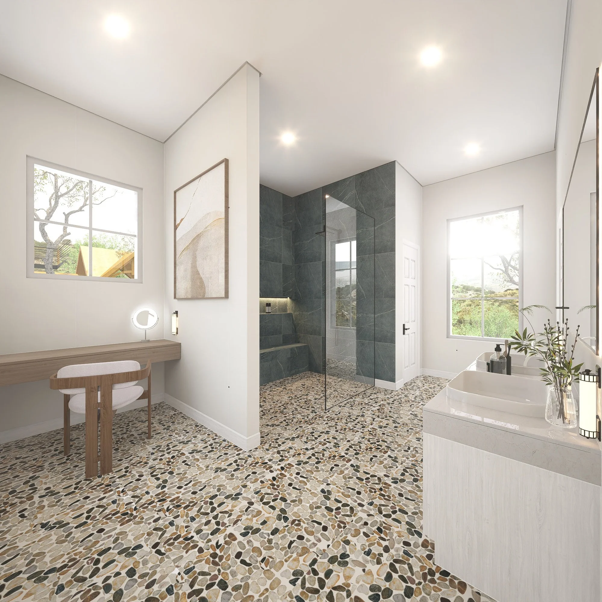 Modern bathroom with white walls, pebble tile flooring, double sinks, large windows, and a glass-enclosed shower with dark gray tiles.