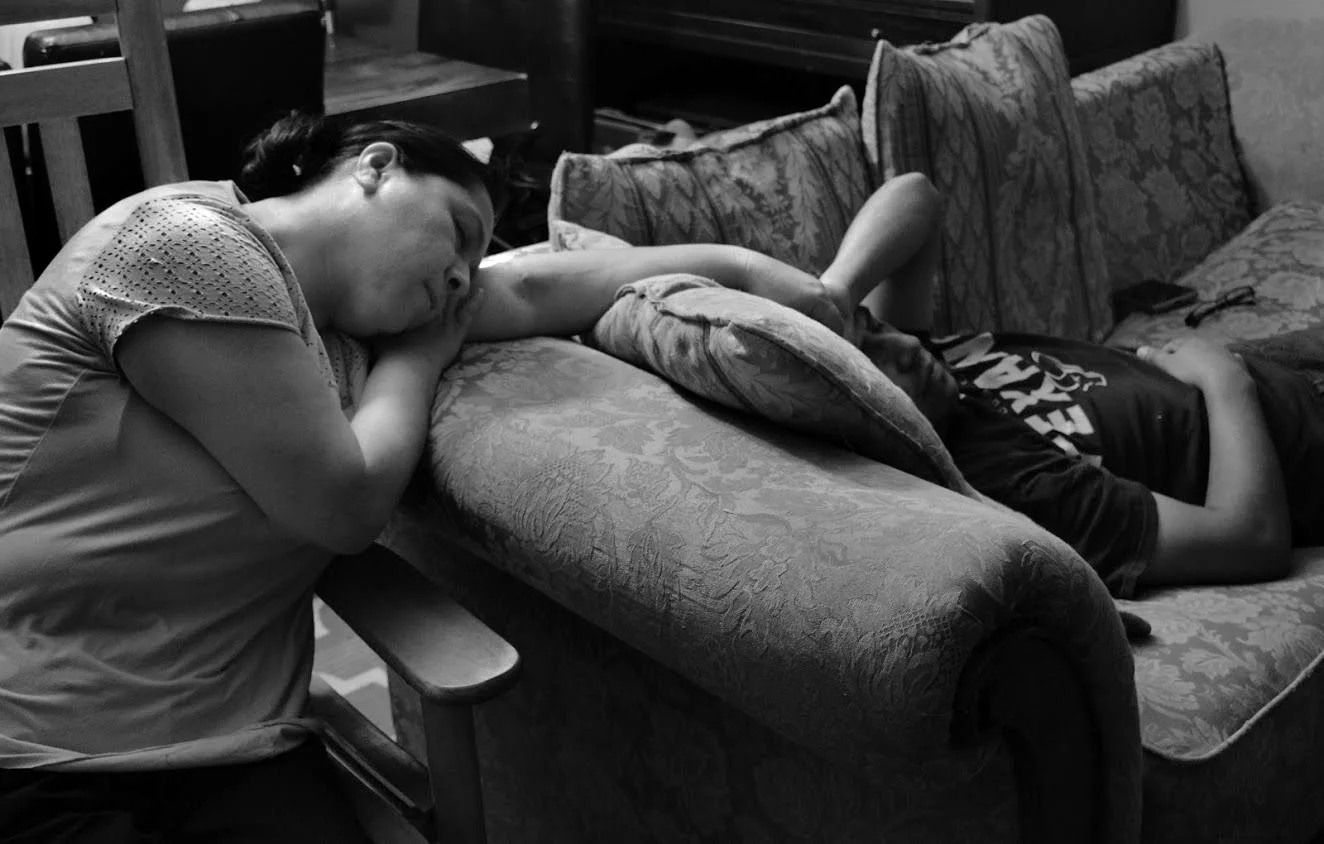 Sheila Morales, "Through It All," 2019. "Marriage is a commitment to always be there for each other in the good and the bad. Here is a picture of my parents holding each other’s hands while taking a nap after a tiring day of work. Though they do comp