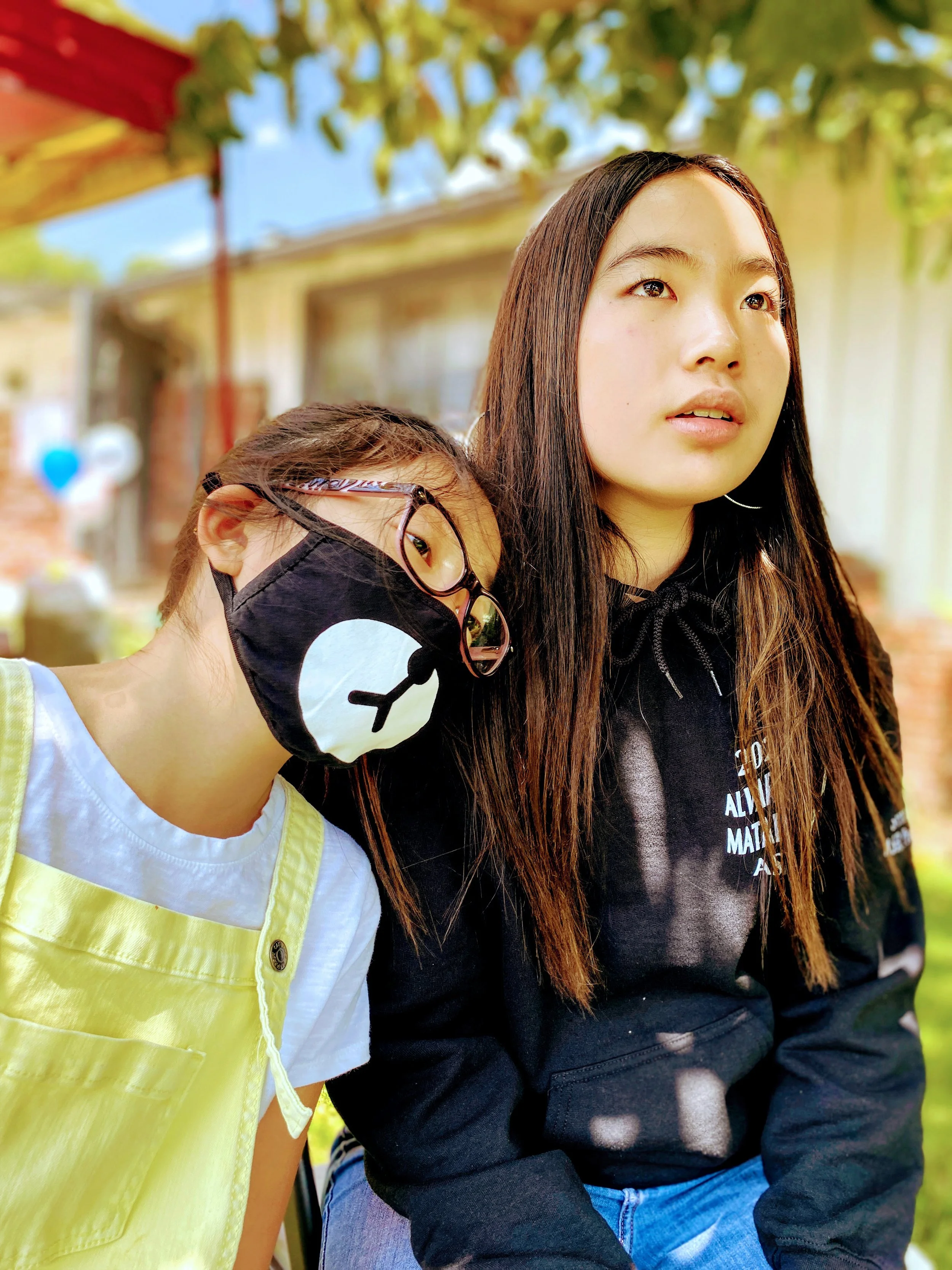 Caitlyn Eng, "It's a Scary Time," 2020. "We try to stay positive during this pandemic, but knowing that this is our new normal has us sad sometimes. These two sisters are my younger cousins, Sienna and Emma. Emma is the little one in yellow. You can