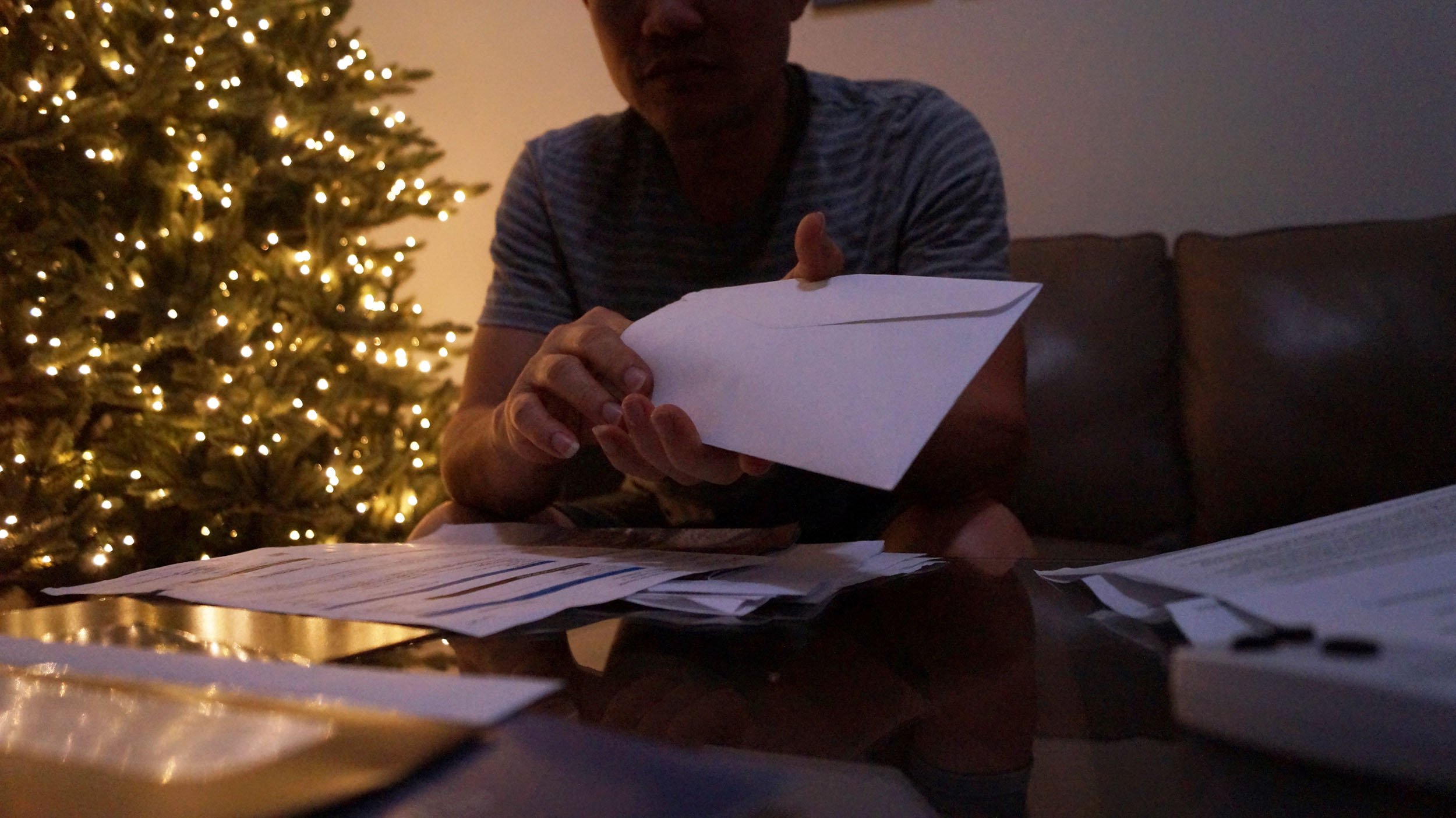 Linh Nguyen, "Work From Home," 2023. The holidays don't mean work is on pause. My dad settles in the living room after Thanksgiving dinner to sort through the mail and pay the bills.
