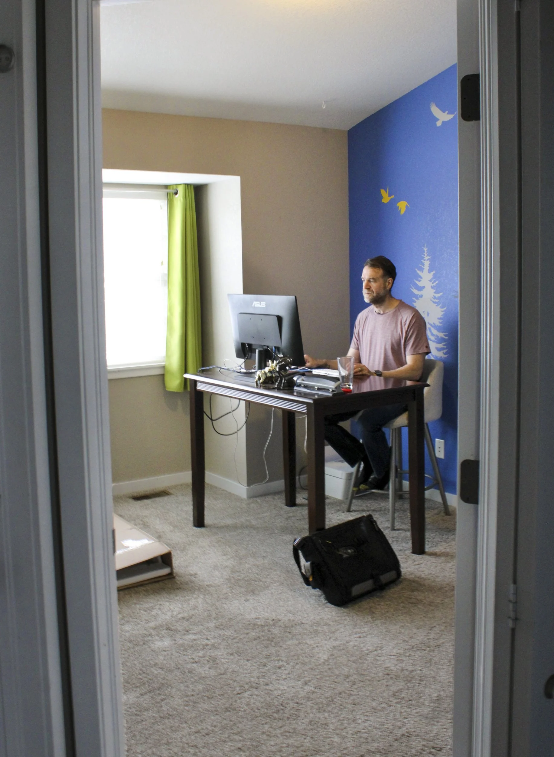 Annabelle Woram, "The Software Engineer," 2022.
I peer through a doorway as my dad sits in his softly-lit home office, thoughtfully completing the rest of his day’s work as a part in-office, part out-of-office software engineer.