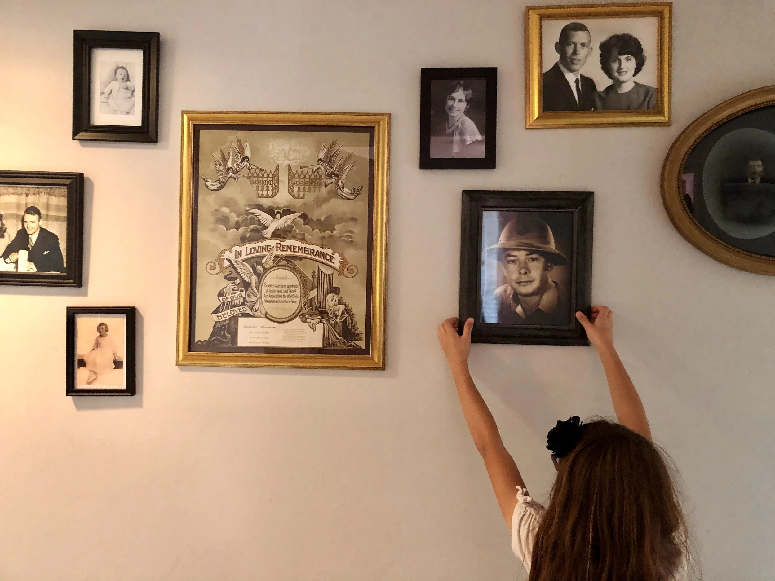 Evie Barnard, "Family Memories," 2020. "Social isolation has been especially hard for my youngest sister. To help occupy her time, my mother has begun assigning her chores to do. The most recent one involved the redecoration of our family wall. Here,