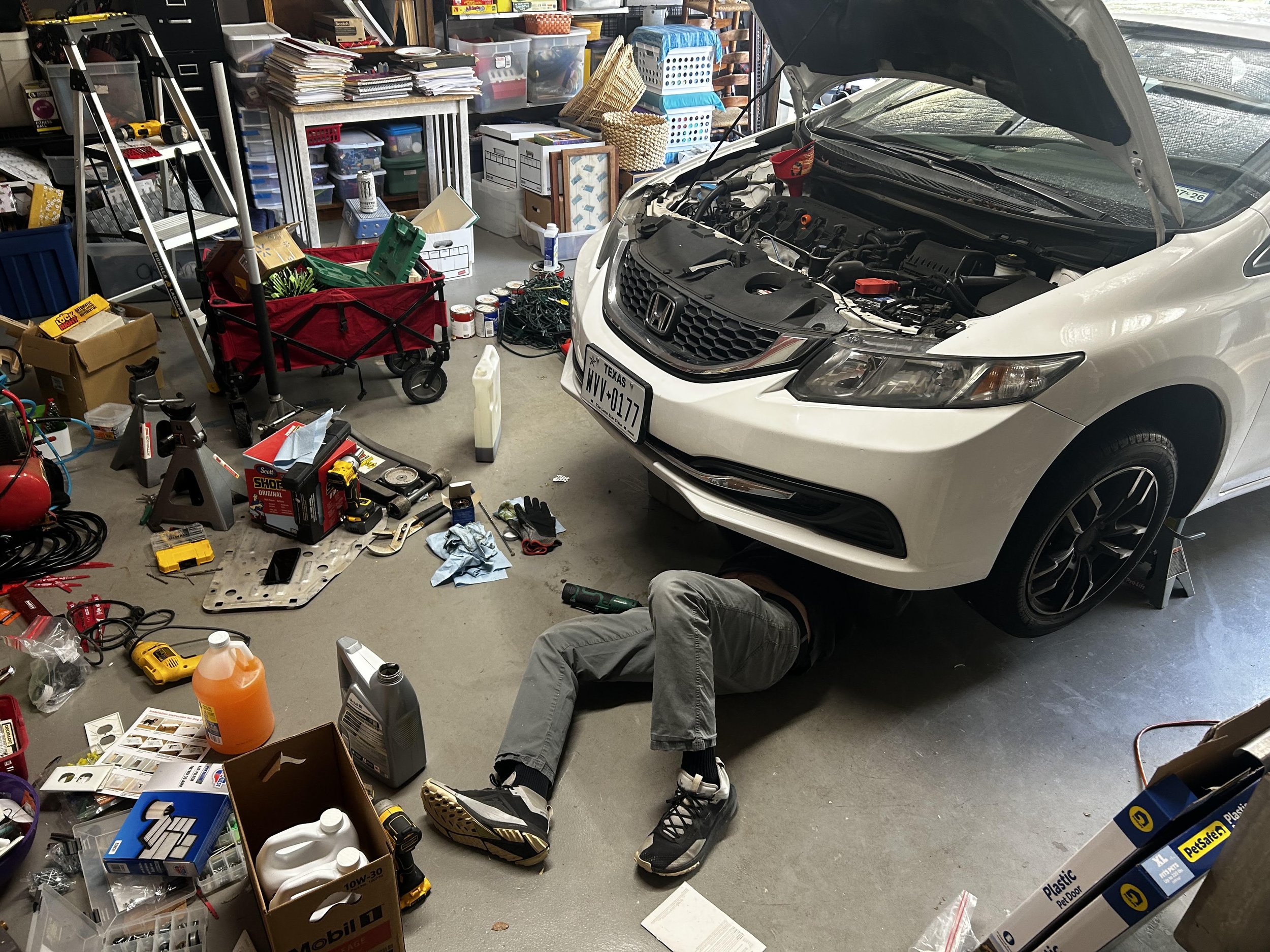 Sean Sander, "Routine Maintenance," 2026. On an early Saturday afternoon, my dad and I work on maintaining my car. Having owned it a while, I thought it would be a good time to change out the old oil for new. Instead of taking the car to a shop and g