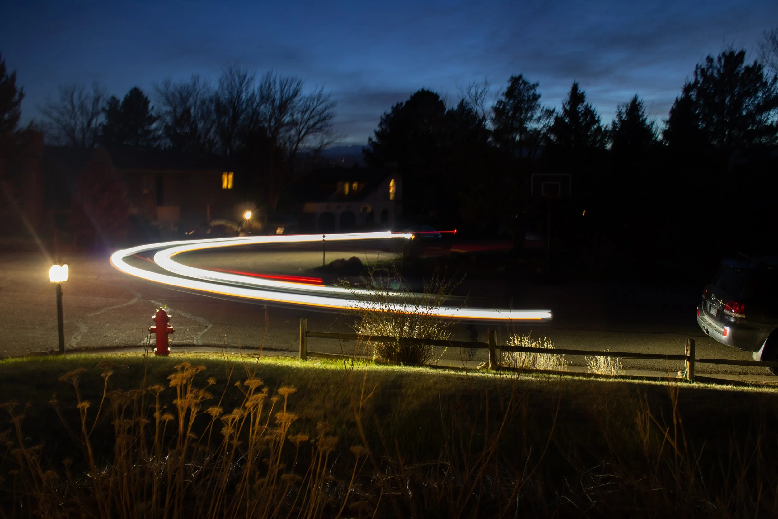 Hayden Heinrichs, "Honey I'm Home," 2022.
It is not an uncommon occurrence in my family for my dad to come home late. This long-exposure photograph pictures my dad finally arriving home after a long day working as a pediatrician. He often has to stay