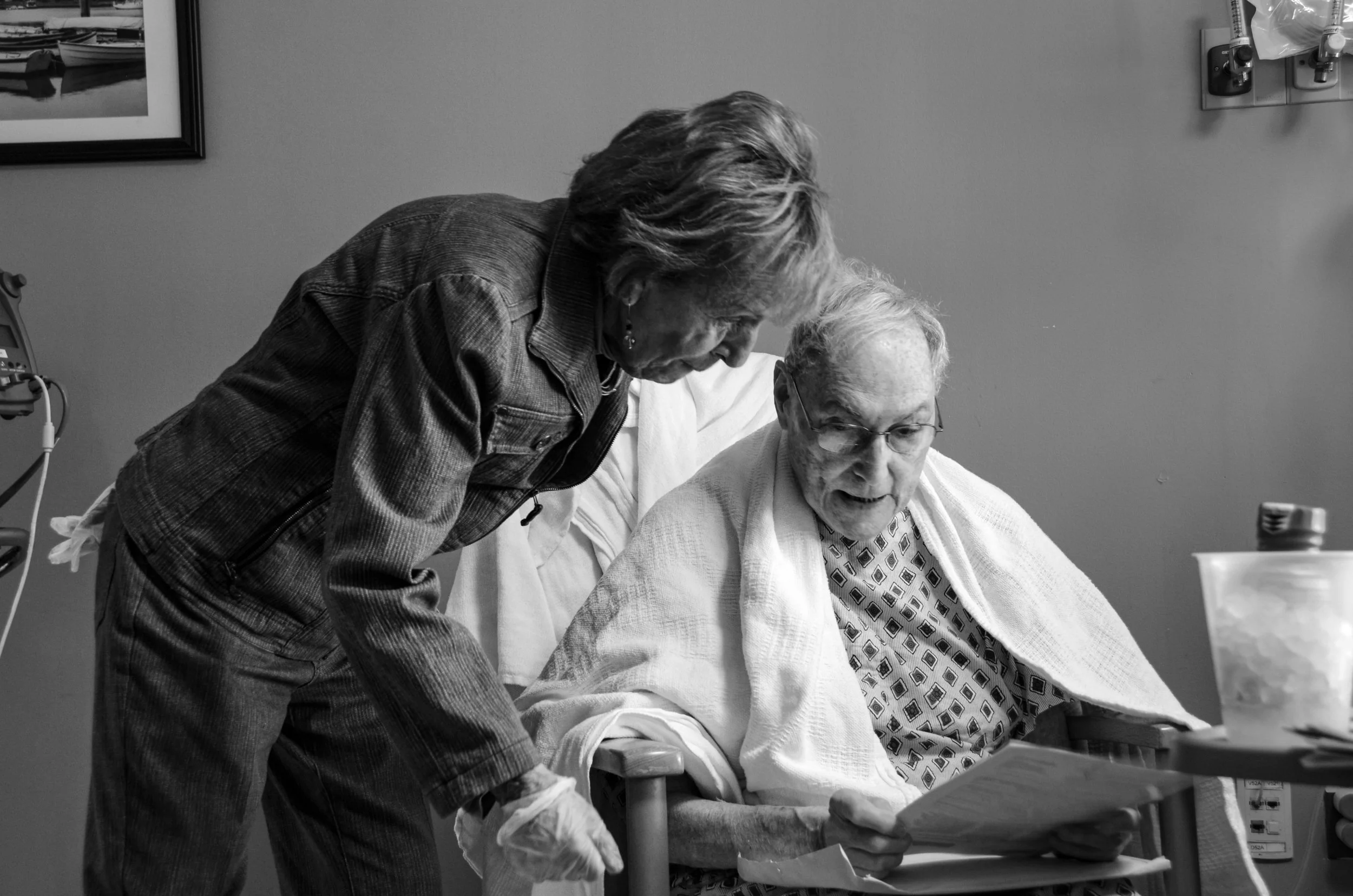 Sydney Sheinfeld, "Together: The Good, Bad, and In-between," 2019. "This frame captures the moment my grandmother assisted my grandfather in analyzing documents and files. This image's depth goes beyond the surface of hospital gloves, hospital gowns,