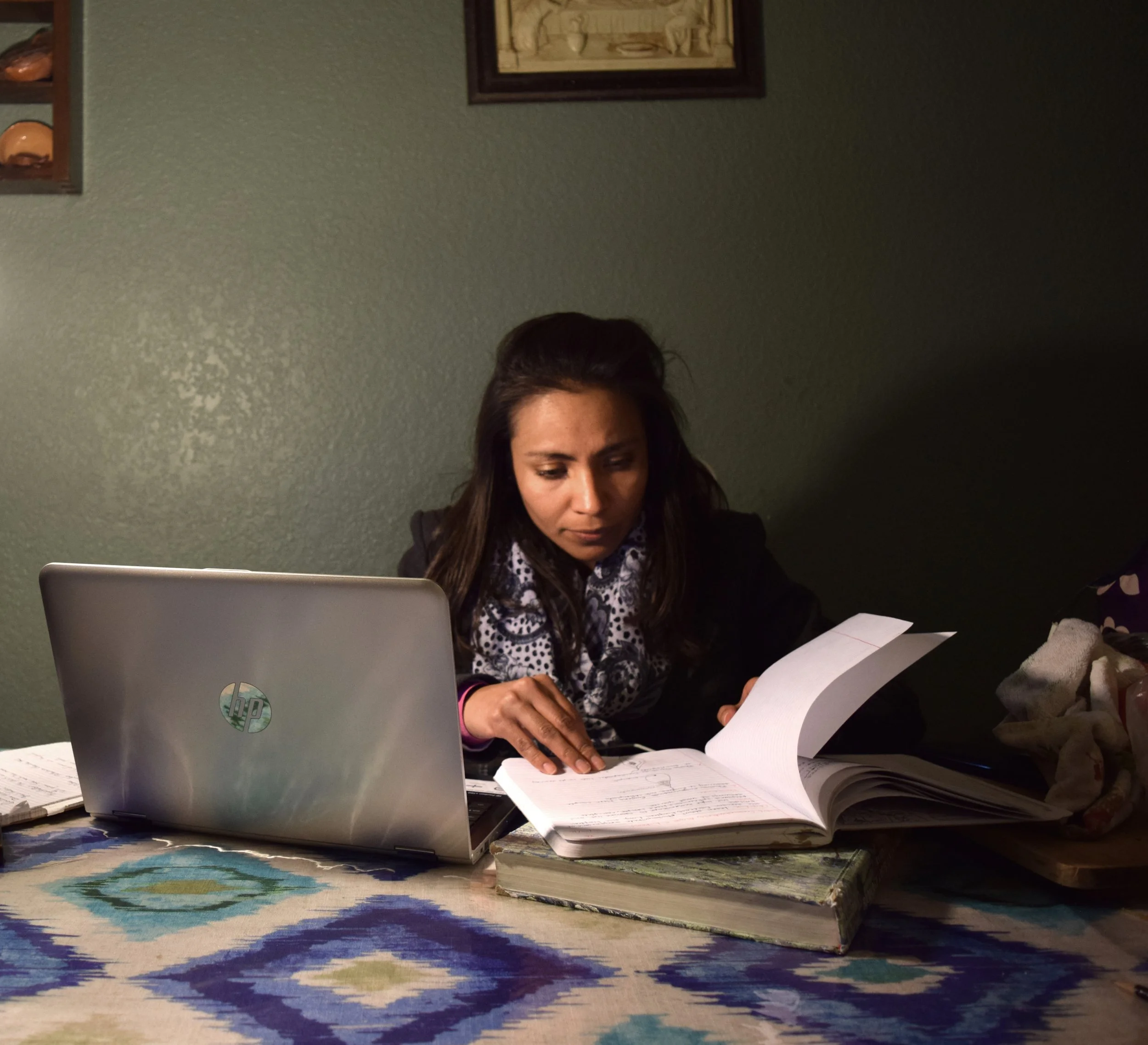 Mariana Luna Valdez, "Untitled," 2018. "Coming home from school, my older sister is the only adult in the house and the one in charge of me and my younger siblings. In this picture, she's trying to study while taking care of us."