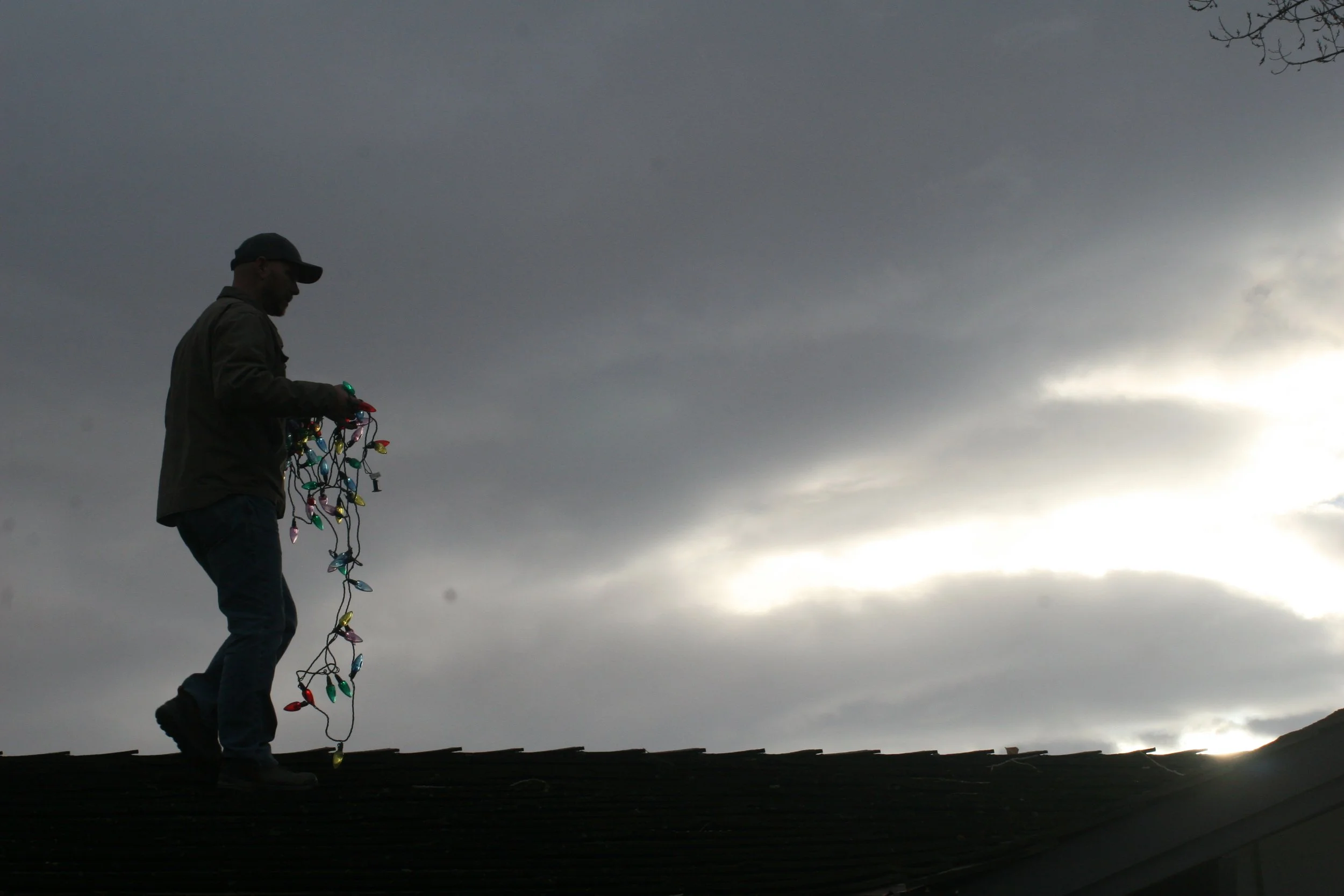 Alexander Gilson, "Lights," 2022.
My dad is helping decorate our house for Christmas by lining the roof with lights. The whole family was working together to decorate our house before the big snow we knew was coming the next day. We watched as a mass