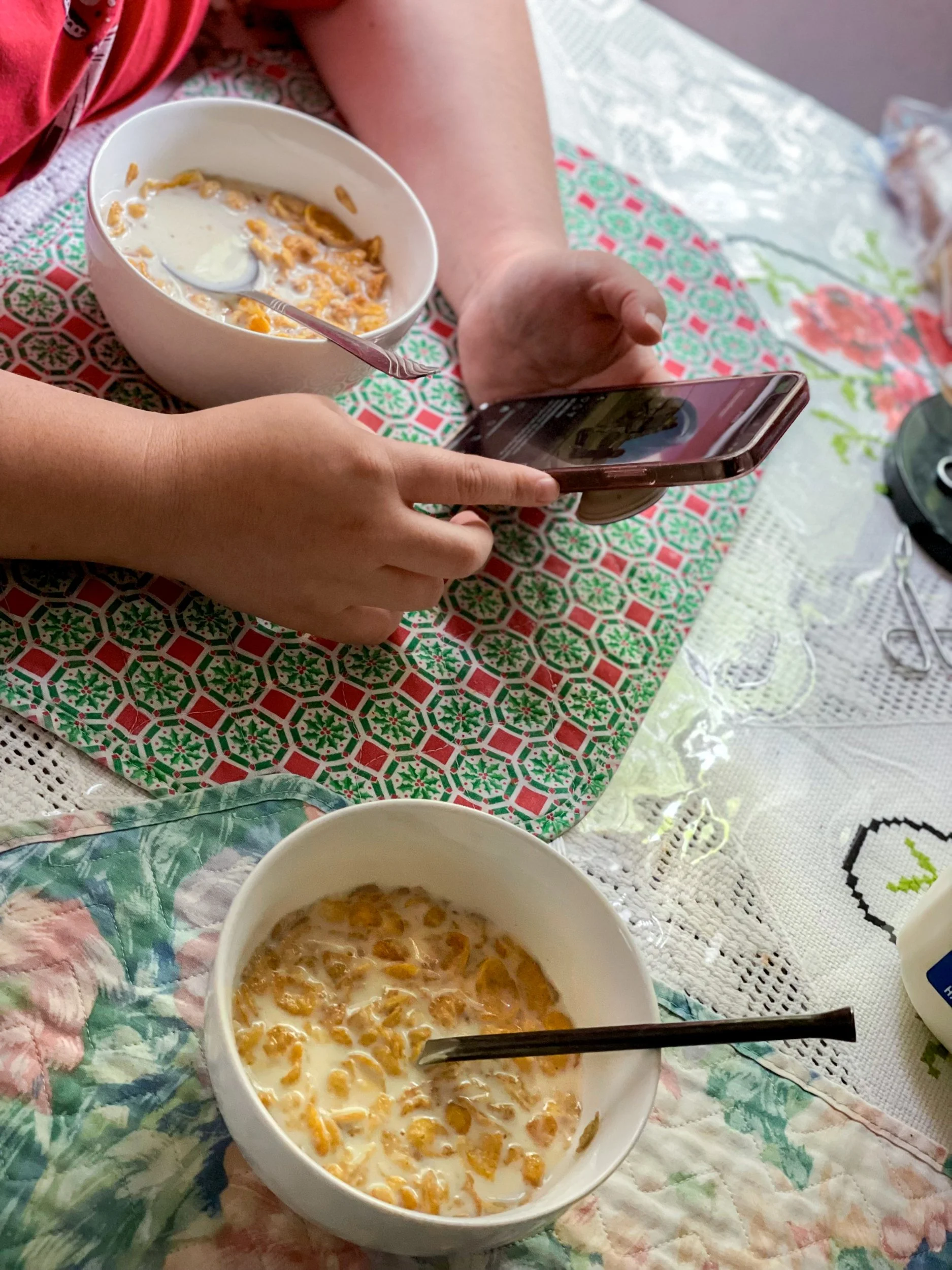 Isabella Hernandez, "Breakfast for 2," 2021. My mother and I usually have to eat by ourselves each morning because my dad is still working. Although my dad is not there physically to have breakfast with us, he is there by phone. My mom talks with my