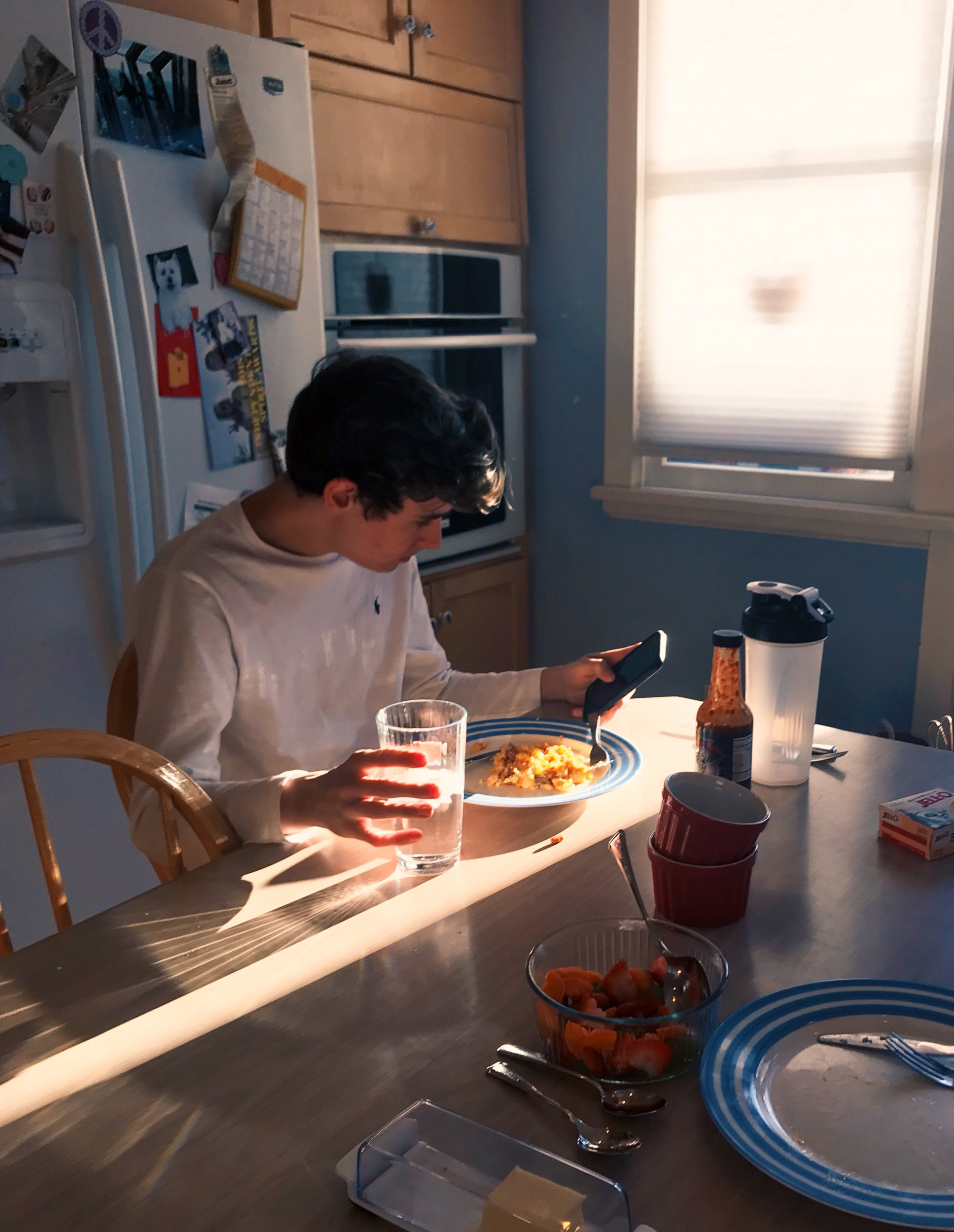 Claire Hallaway, "Untitled," 2018. "This image captures what an everyday morning before school looks like in my home. My dad is retired so a lot of the work he does involves cooking all of the meals for my family. He says he enjoys waking up extra ea
