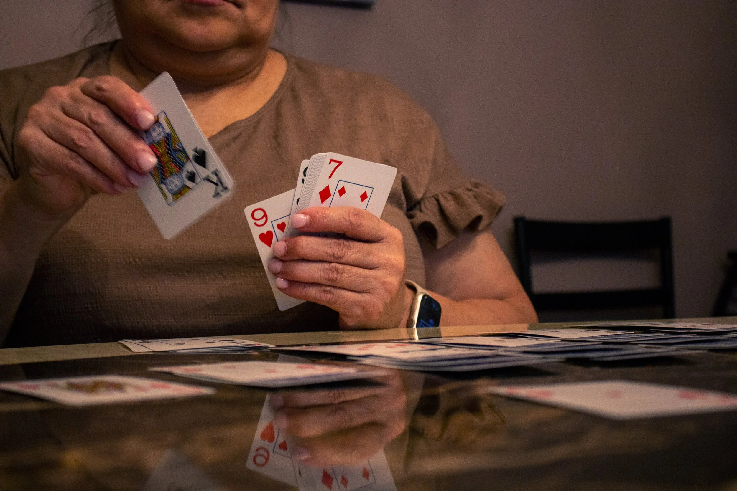 Jarron Contreras Gonzales, "Preparing for Work," 2022.
My mom finally found a job at the casino as a card dealer. She practices dealing cards with herself and even deals some games for my brother to prepare. My mom is very excited to start working ag