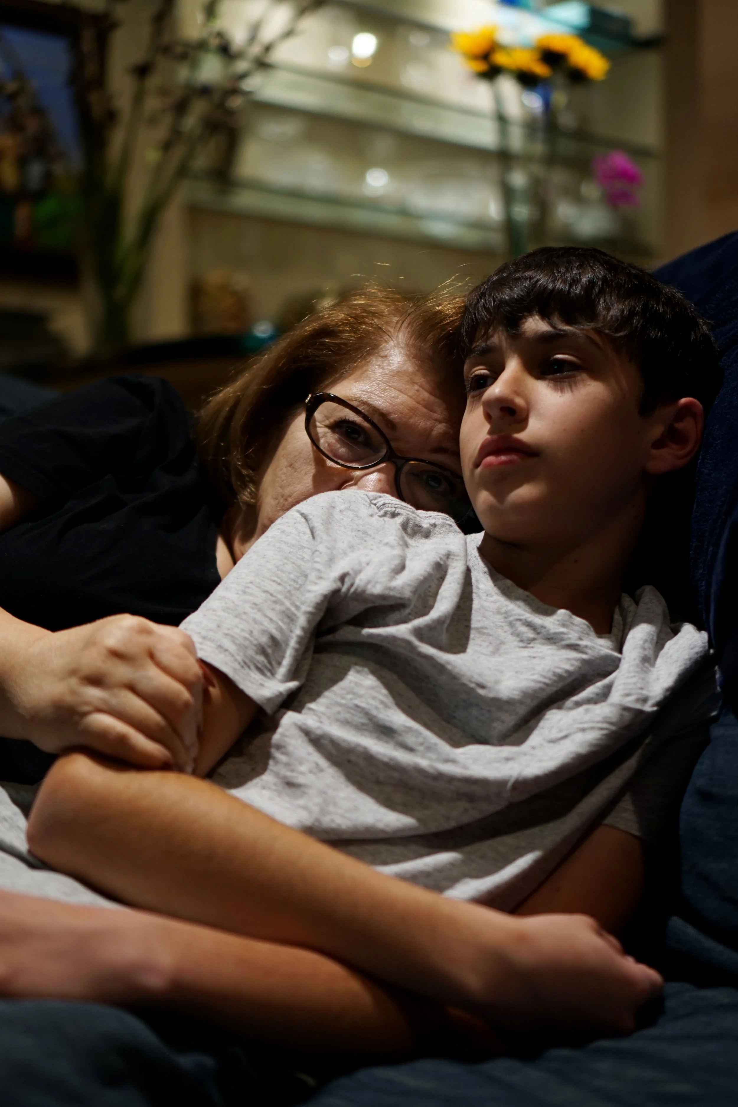 Aneese Nadaf, "Untitled," 2020. "Because my dad leaves for work trips every weekend, my grandparents tend to come over and watch us. This night, my grandmother and brother sat together watching TV while my dad was busy working 5 hours away."