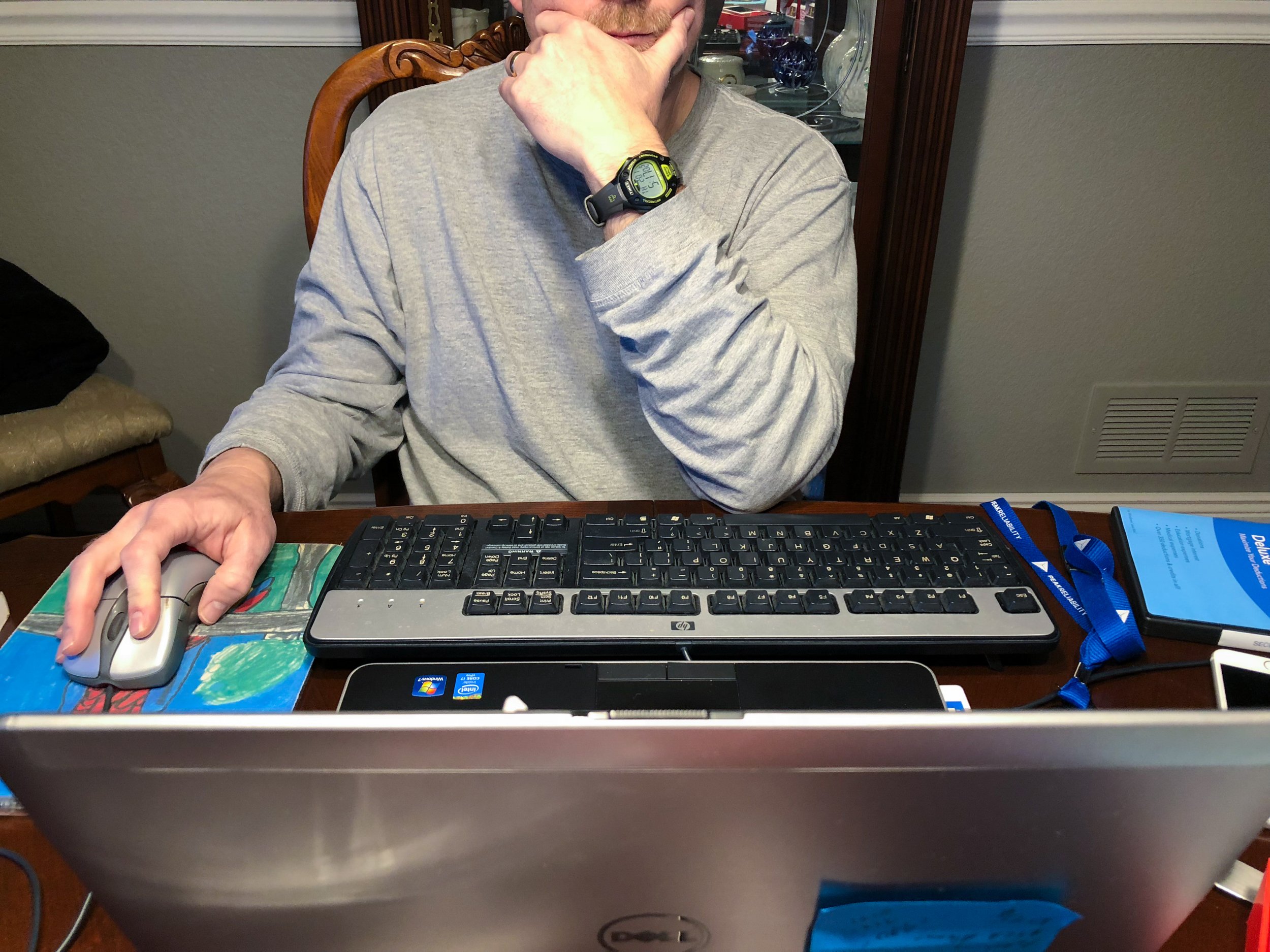 CJ, "Untitled," 2018. "This is an image of my dad working on his computer at home. A lot of his work is confidential, so I was unable to take pictures up close. For this project, I wanted my photos to show the relationship between my parents' work li