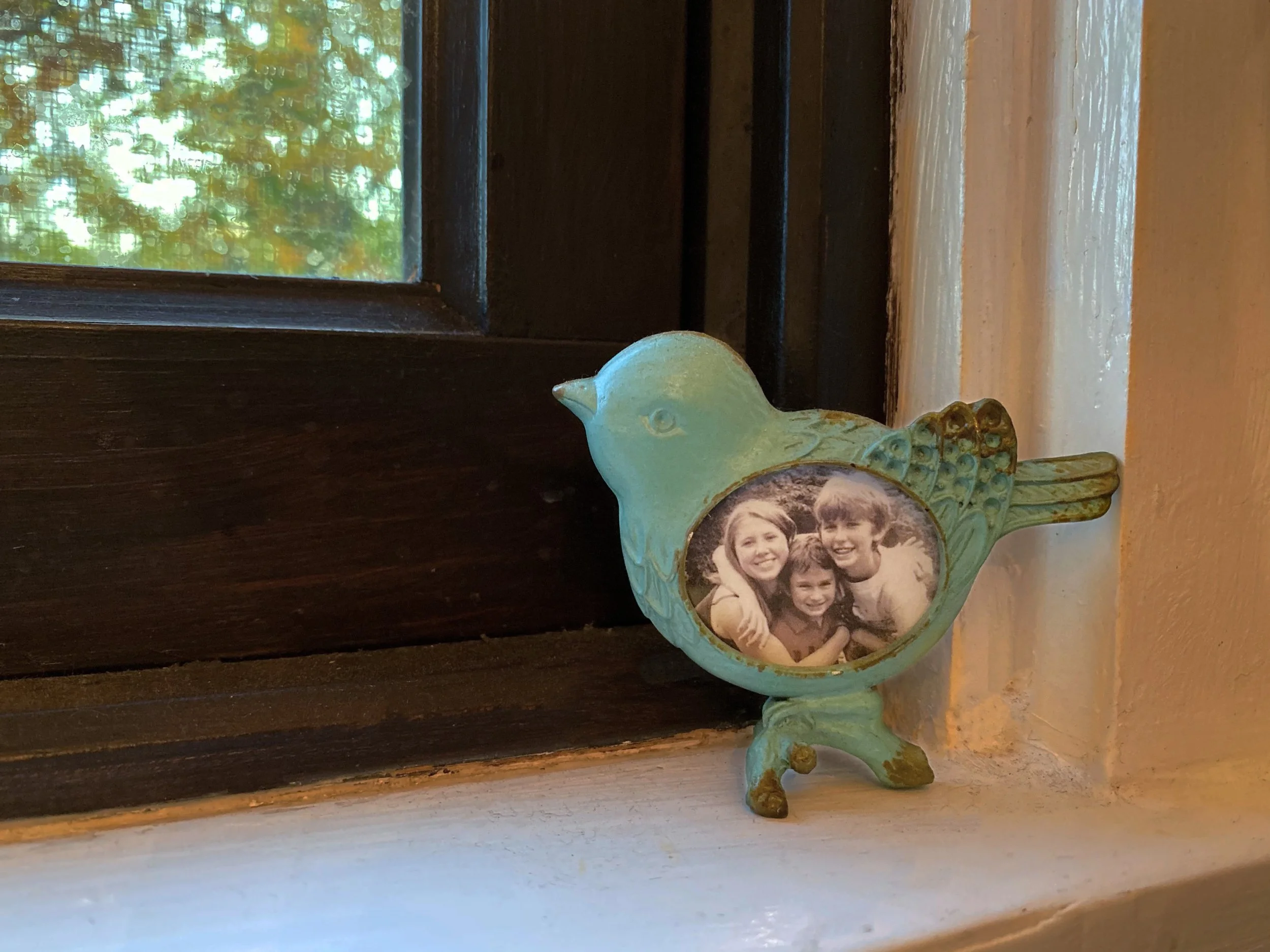 Ian Matenaer, "Three Little Birds," 2019. "When I was younger, my mom used to sing the song about three little birds to my siblings and me. She has now immortalized us in a picture above the kitchen sink, so that her three little birds are always wat
