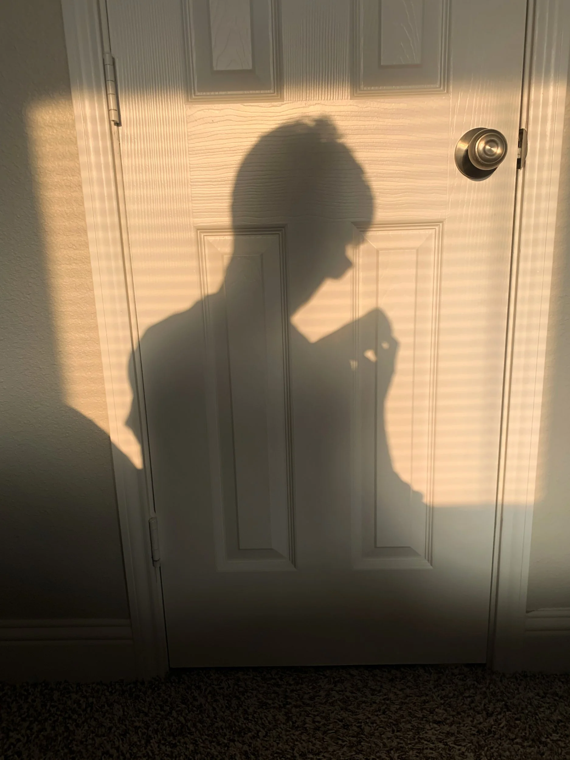 Joshua Garcia, "Shadows," 2021. As I am feeding the baby, I see not only a big brother but someone who can be a father. These two can cast the same shadow. I learned what to do from my parents, and now I do what they taught me.