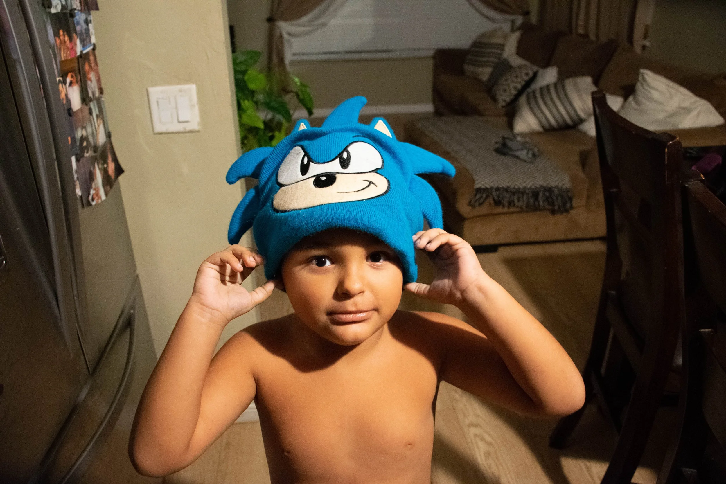 Damian Solis, "Beanie," 2022.
After getting my brother food, I pull out the camera, and he puts his beanie on and poses.