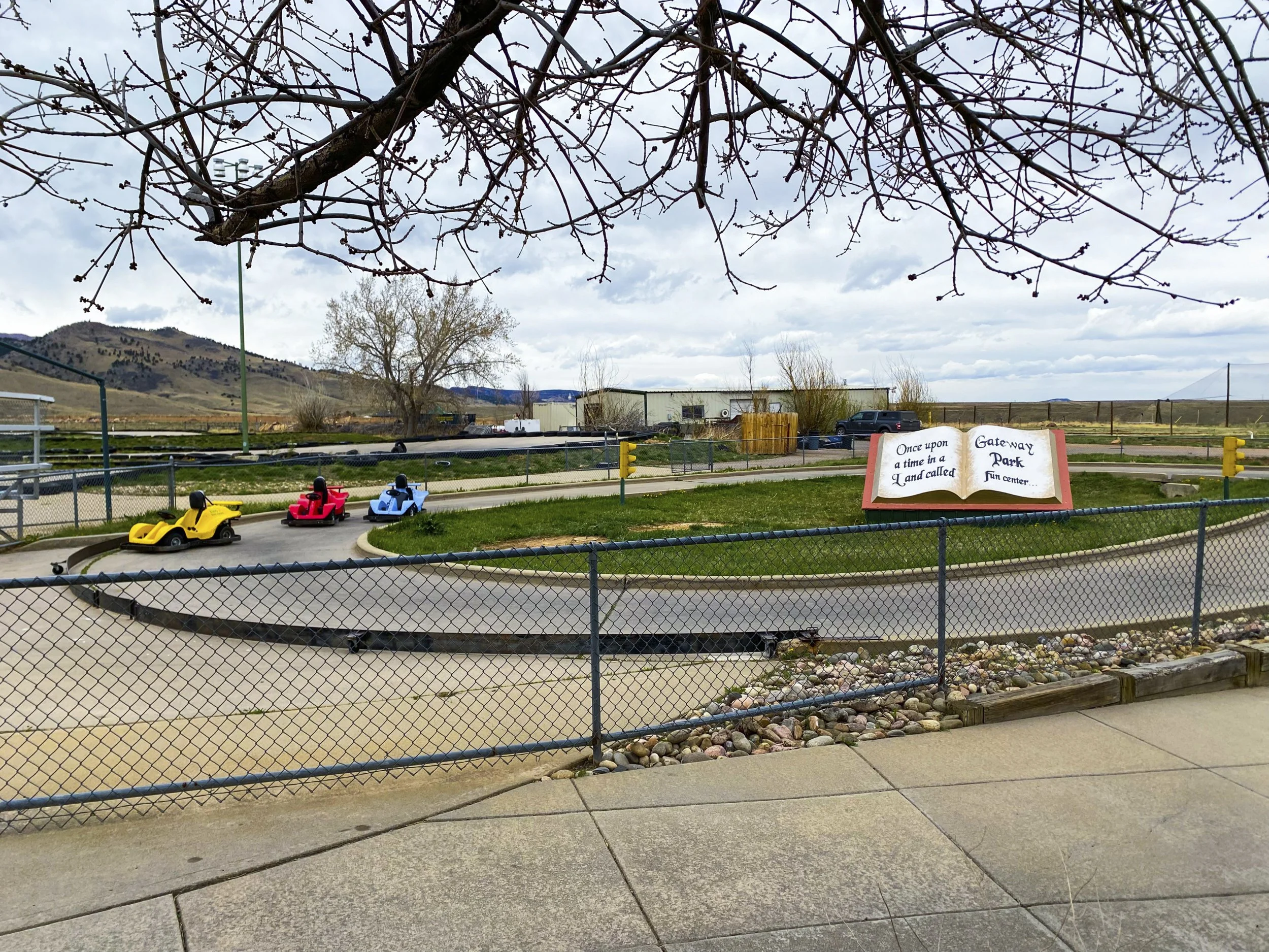 Annabelle Woram, "Once Upon a GoKart Race," 2022.
While working a shift at my part-time job in Boulder, I step outside to capture the briefly deserted go-kart track dedicated to our young patrons. Carelessly sprawled out, colorful go-karts sit idly o