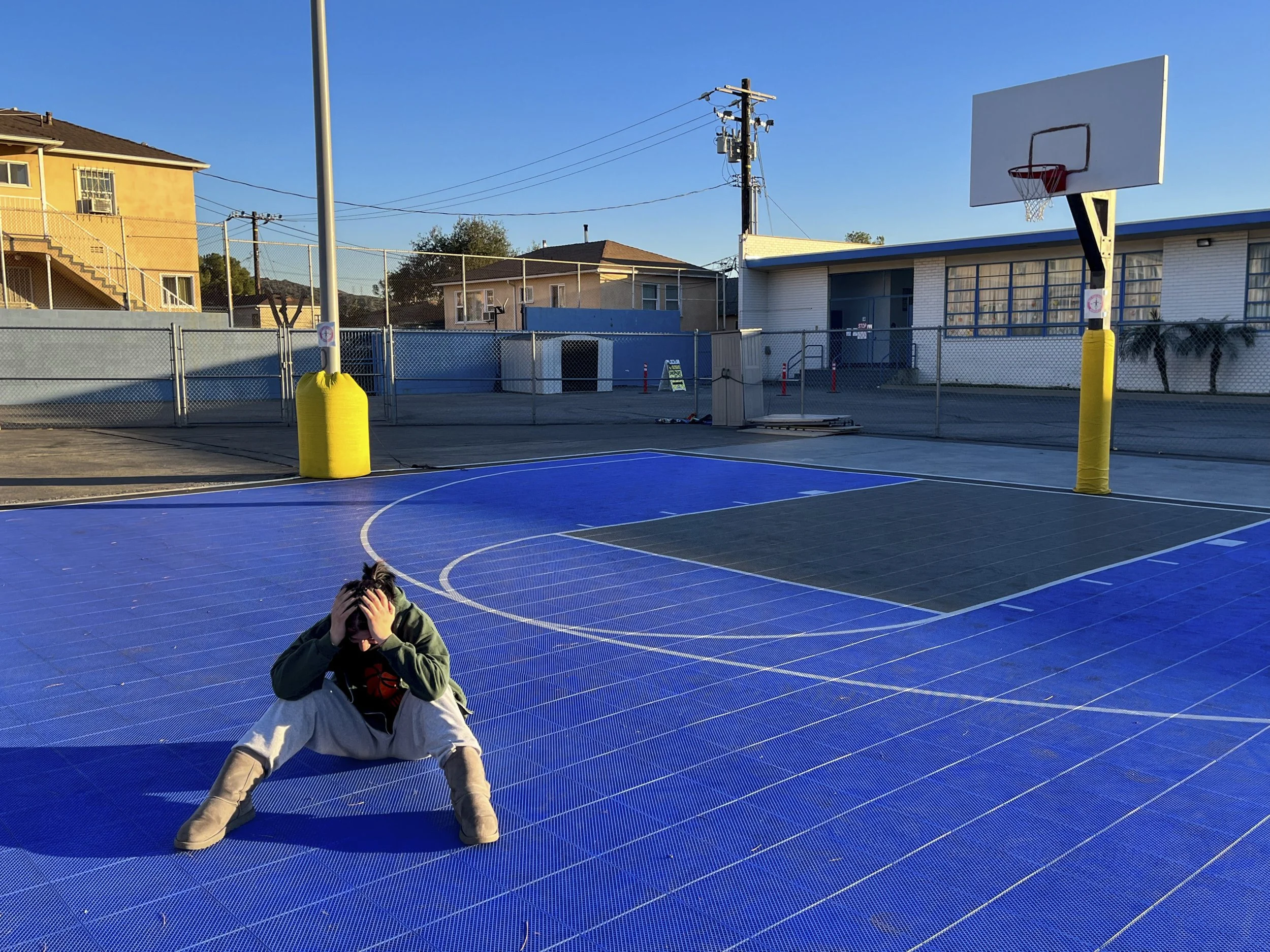 Lia Jones, "Empty Schoolyard," 2022.
After driving to our job, my friend and I take three minutes to rest before the court floods with children and their parents. We often talk about school drama or how our families deal with the neverending pandemic