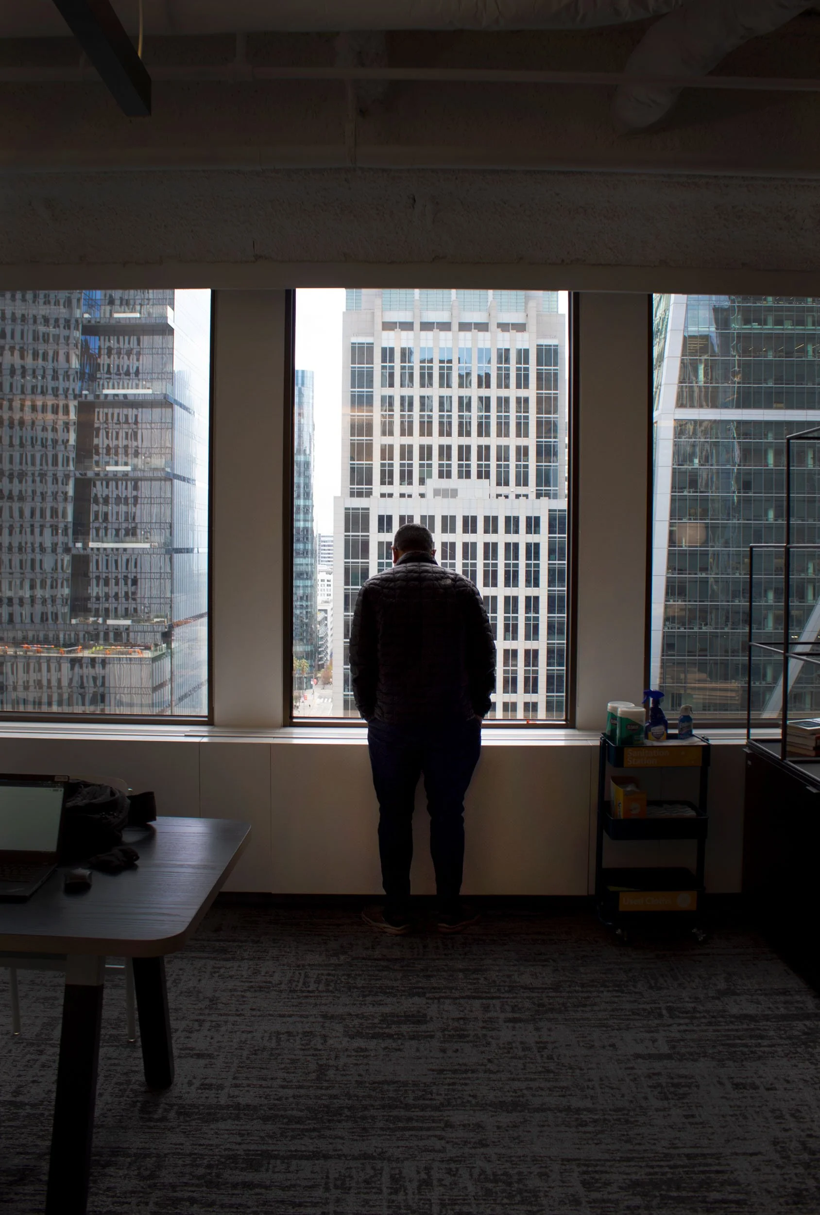 Emmett Tjen, "Empty Office," 2023. My dad looks out the window of his empty office. Because of the pandemic, he's one of the few people that works at his company's new office. This day, he's the only person there.